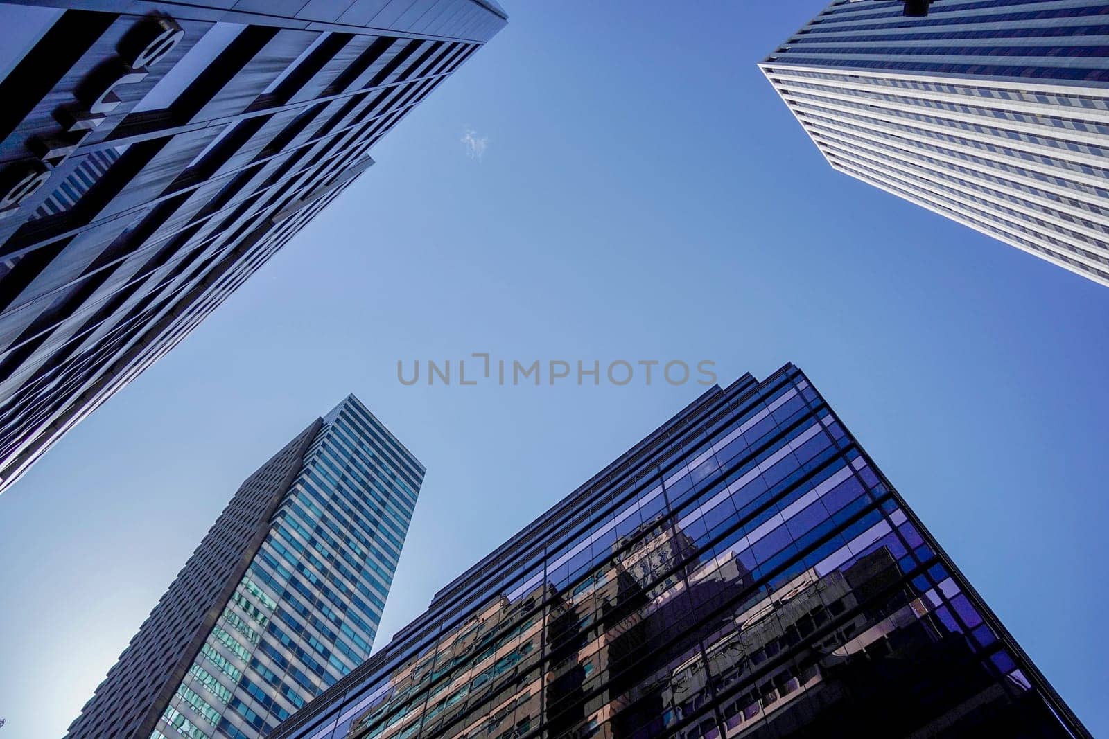 new york city manhattan skyscrapers view from the street to the top of the building on sunny clear day