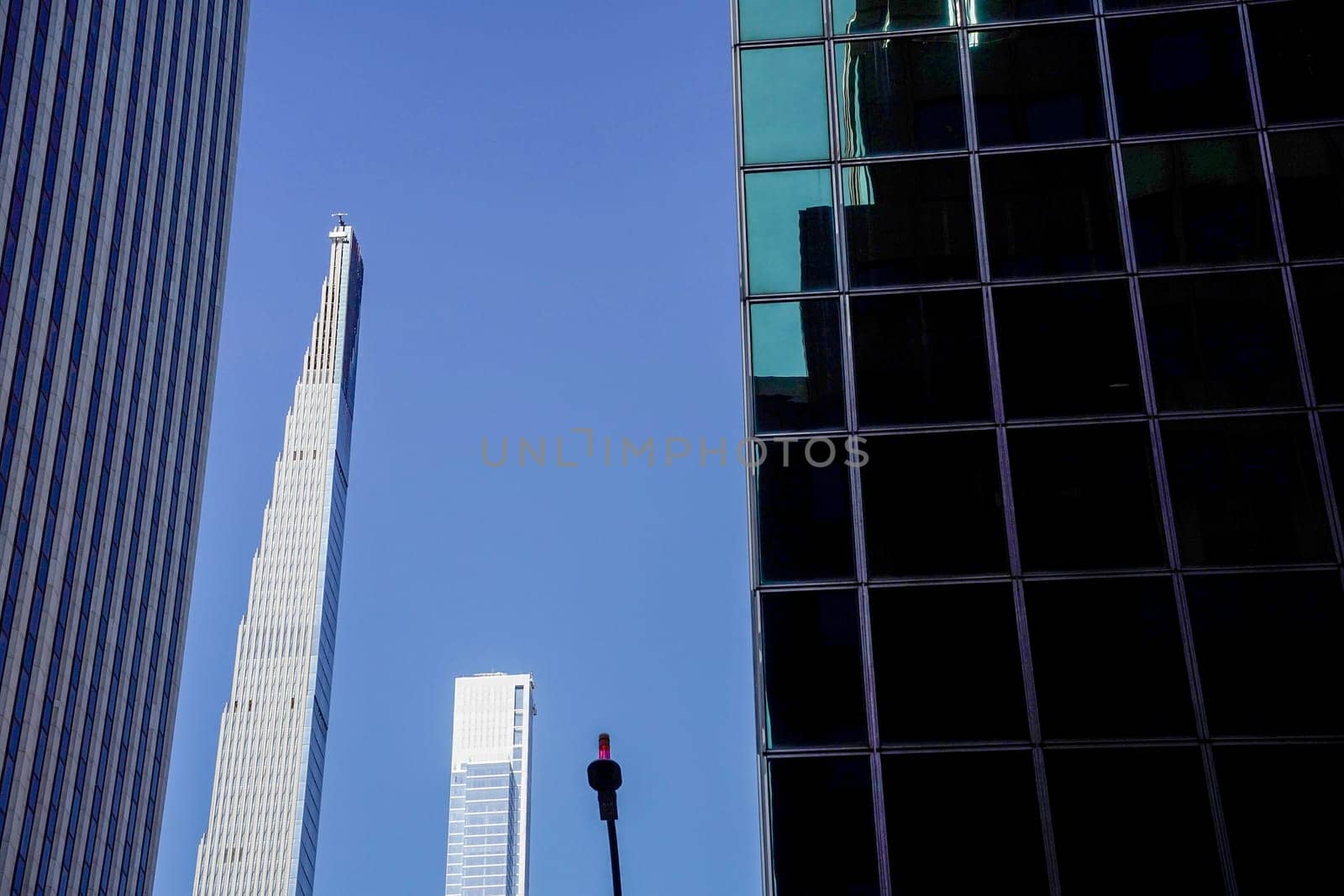 new york city manhattan skyscrapers view from the street to the top of the building on sunny clear day