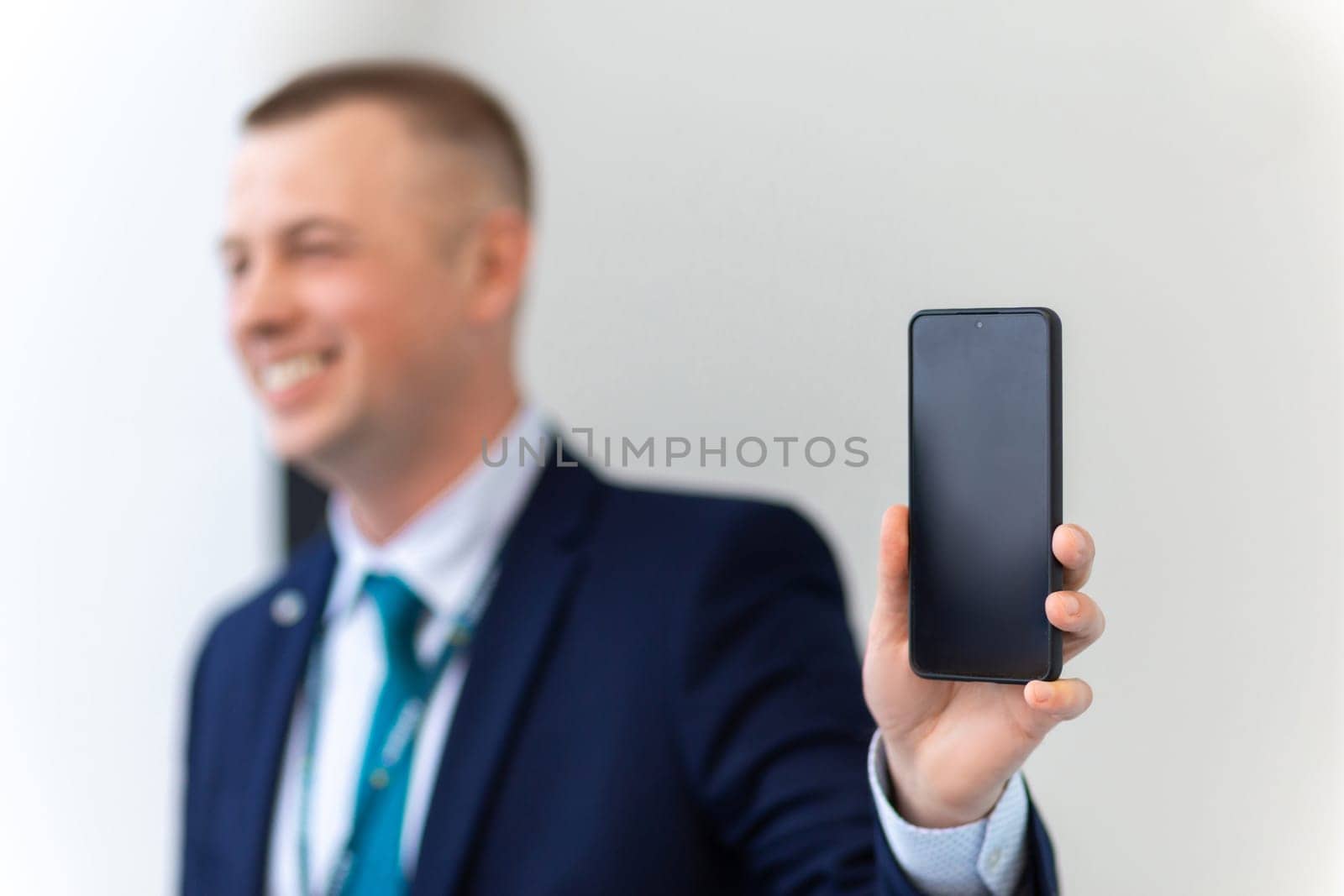 Handsome European Businessman Showing Smartphone With Black Screen At Camera. Smiling Caucasian Male Entrepreneur Demonstrating Copy Space, Advertising New App Or Mobile Offer.