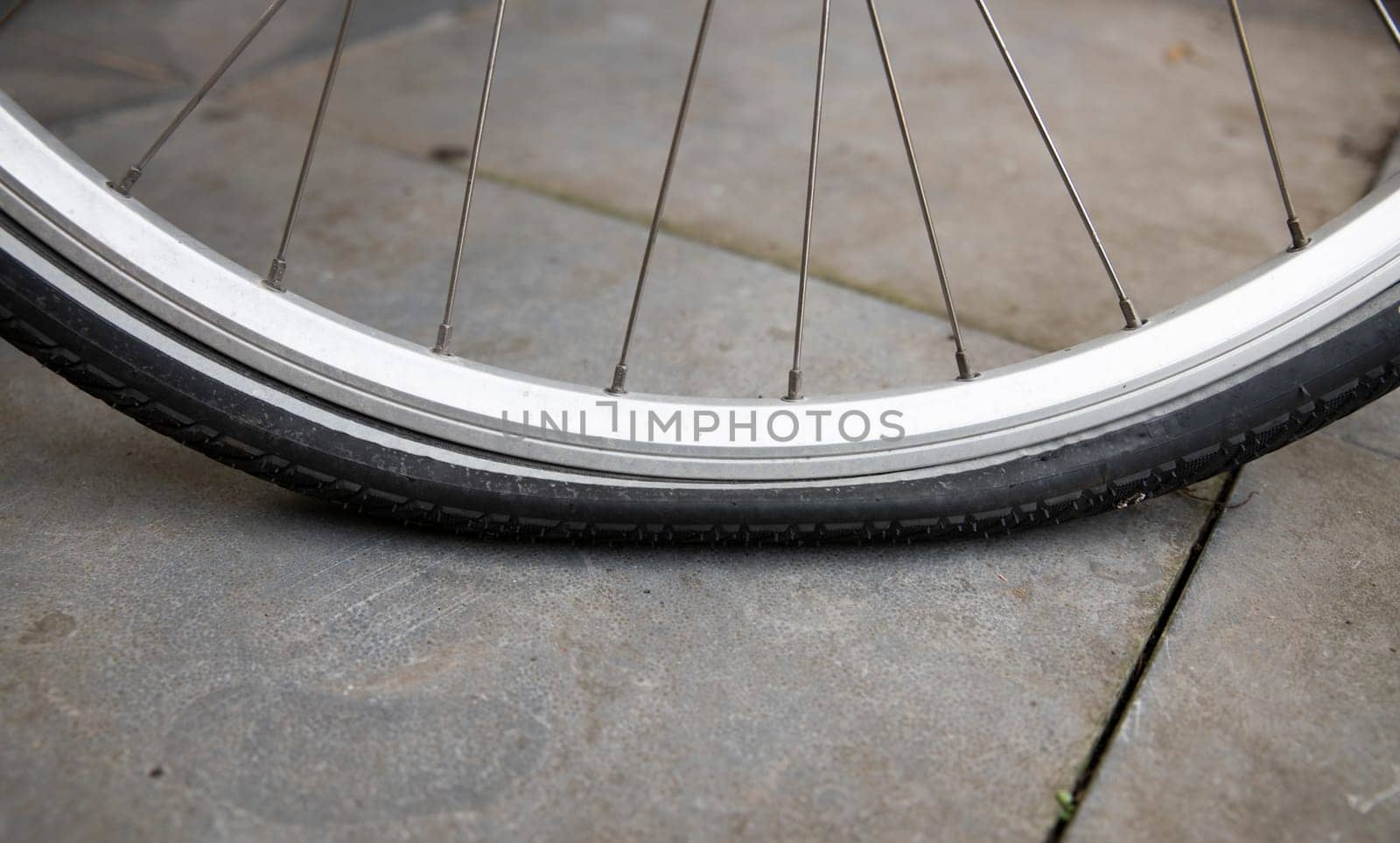bicycle with flat tire by compuinfoto