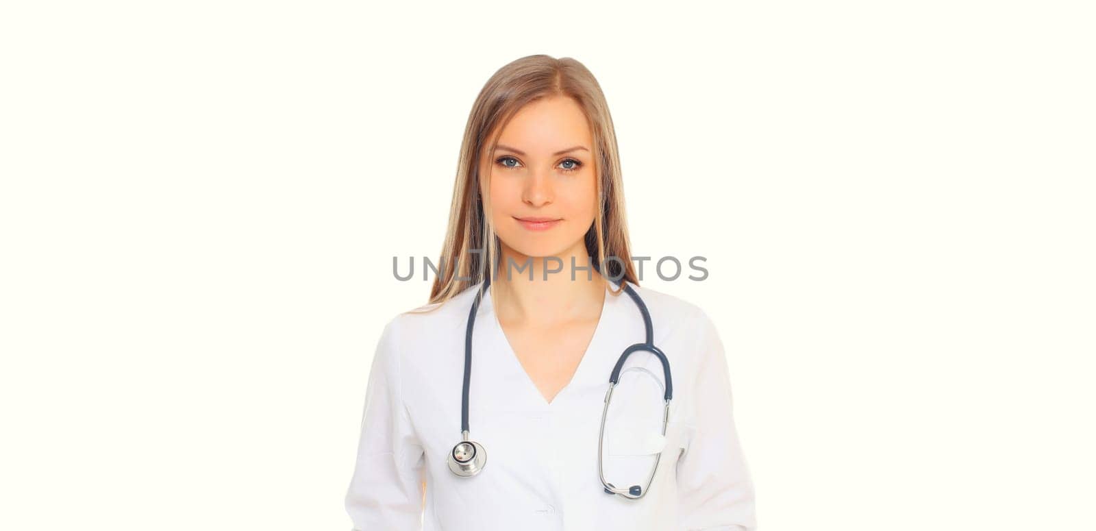 Portrait of happy friendly smiling young woman doctor with stethoscope posing on white studio background