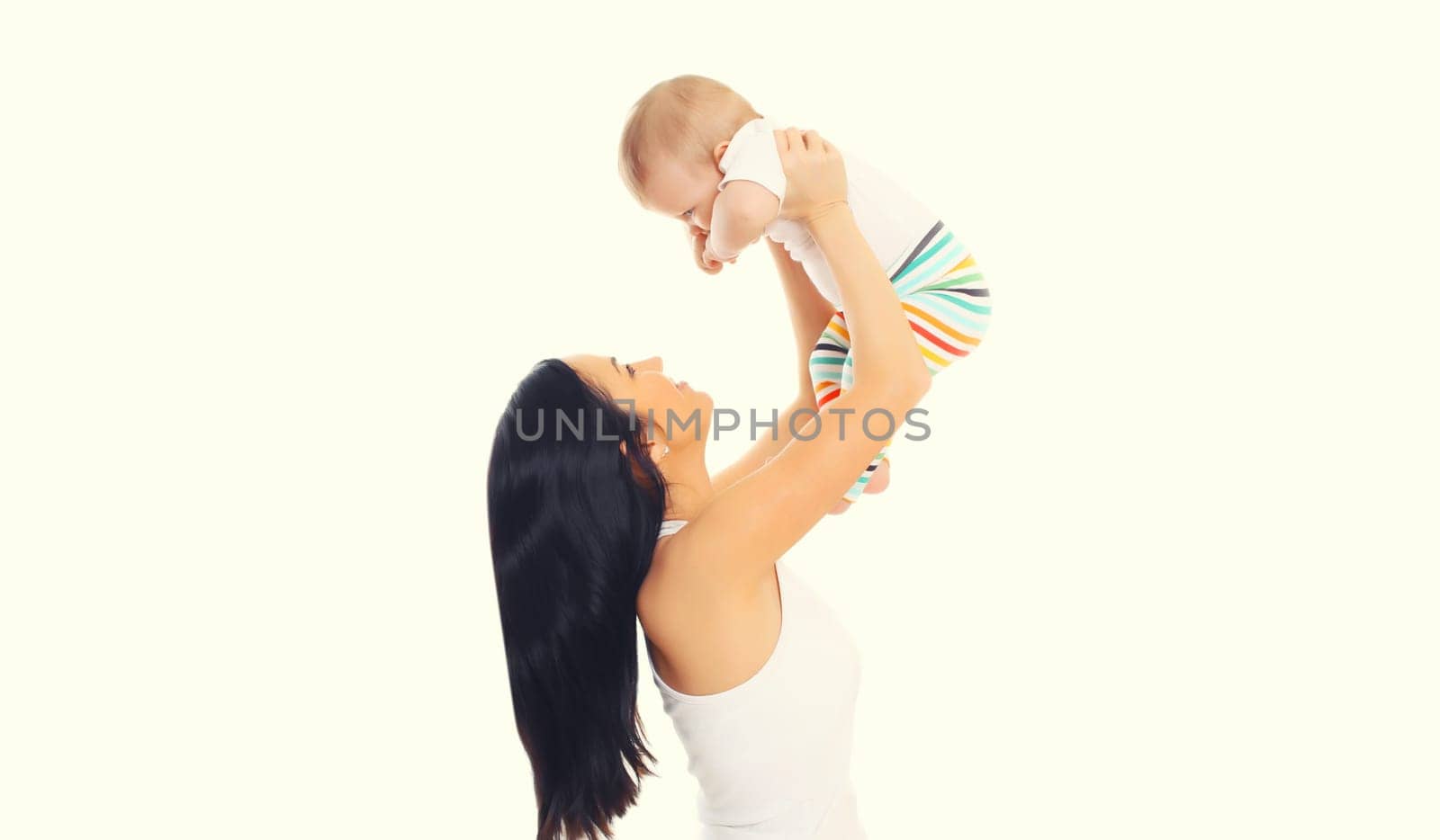 Happy cheerful smiling young mother playing with cute baby on white studio background