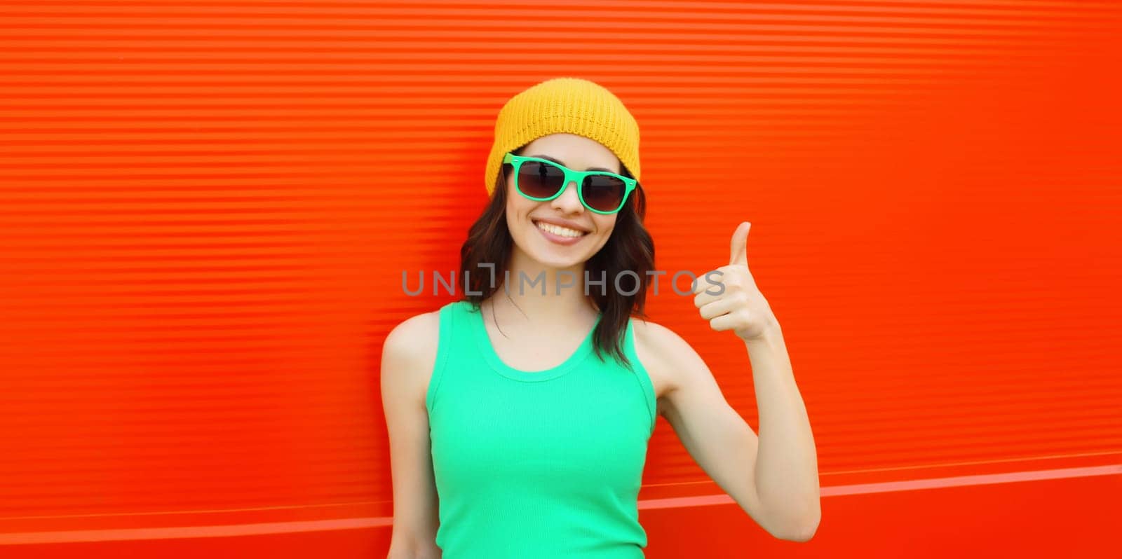 Summer portrait of happy smiling brunette young woman posing in yellow hat, green sunglasses by Rohappy