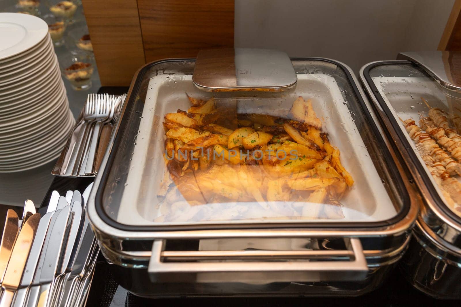Fried potatoes garnish in a food warmer by BY-_-BY