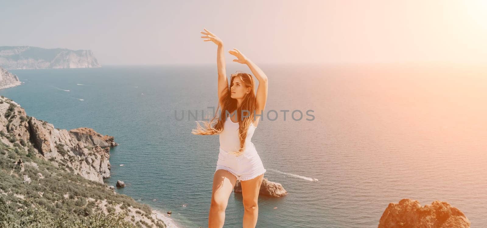 Woman summer travel sea. Happy tourist enjoy taking picture outdoors for memories. Woman traveler posing over sea bay surrounded by volcanic mountains, sharing travel adventure journey by panophotograph