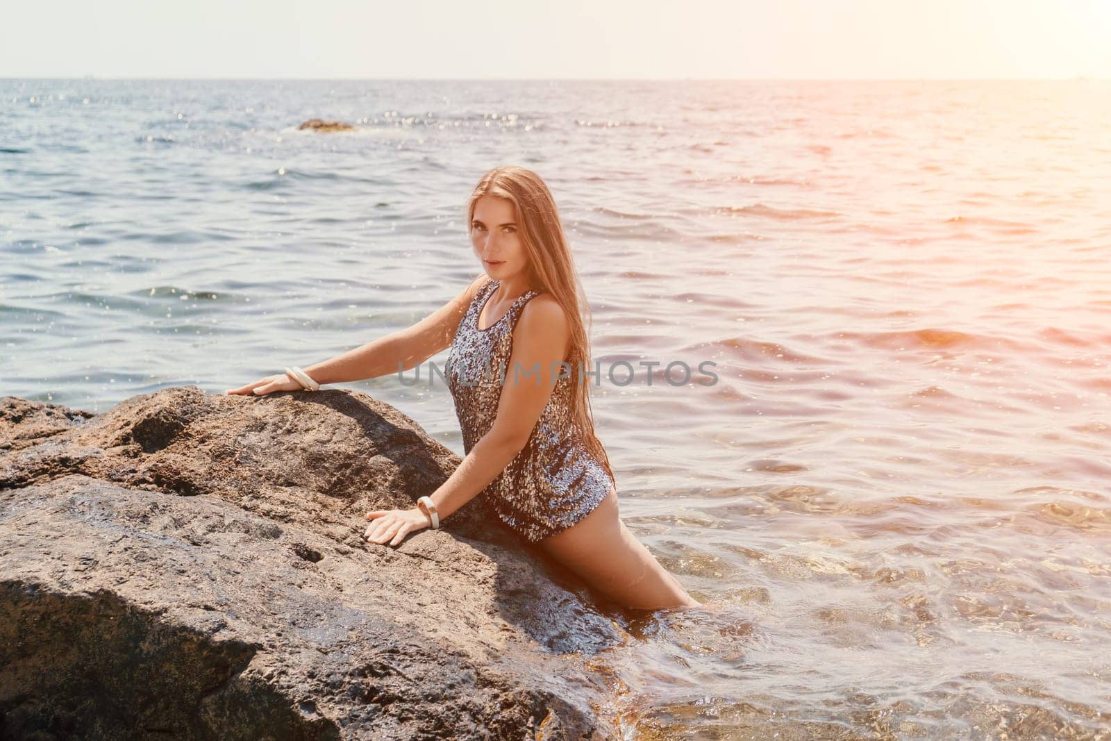 Woman summer travel sea. Happy tourist enjoy taking picture outdoors for memories. Woman traveler posing on the beach at sea surrounded by volcanic mountains, sharing travel adventure journey by panophotograph