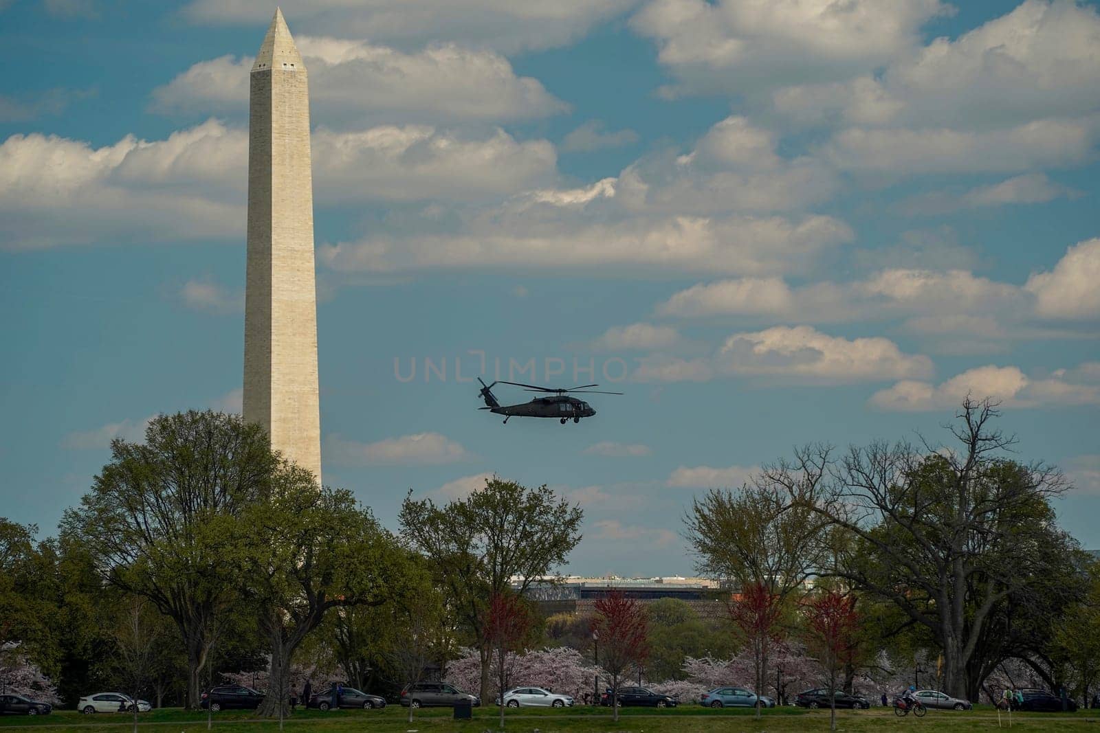helicopter flying near the george washington monument cruise on potomac river washignton dc on riverboat water taxi by AndreaIzzotti