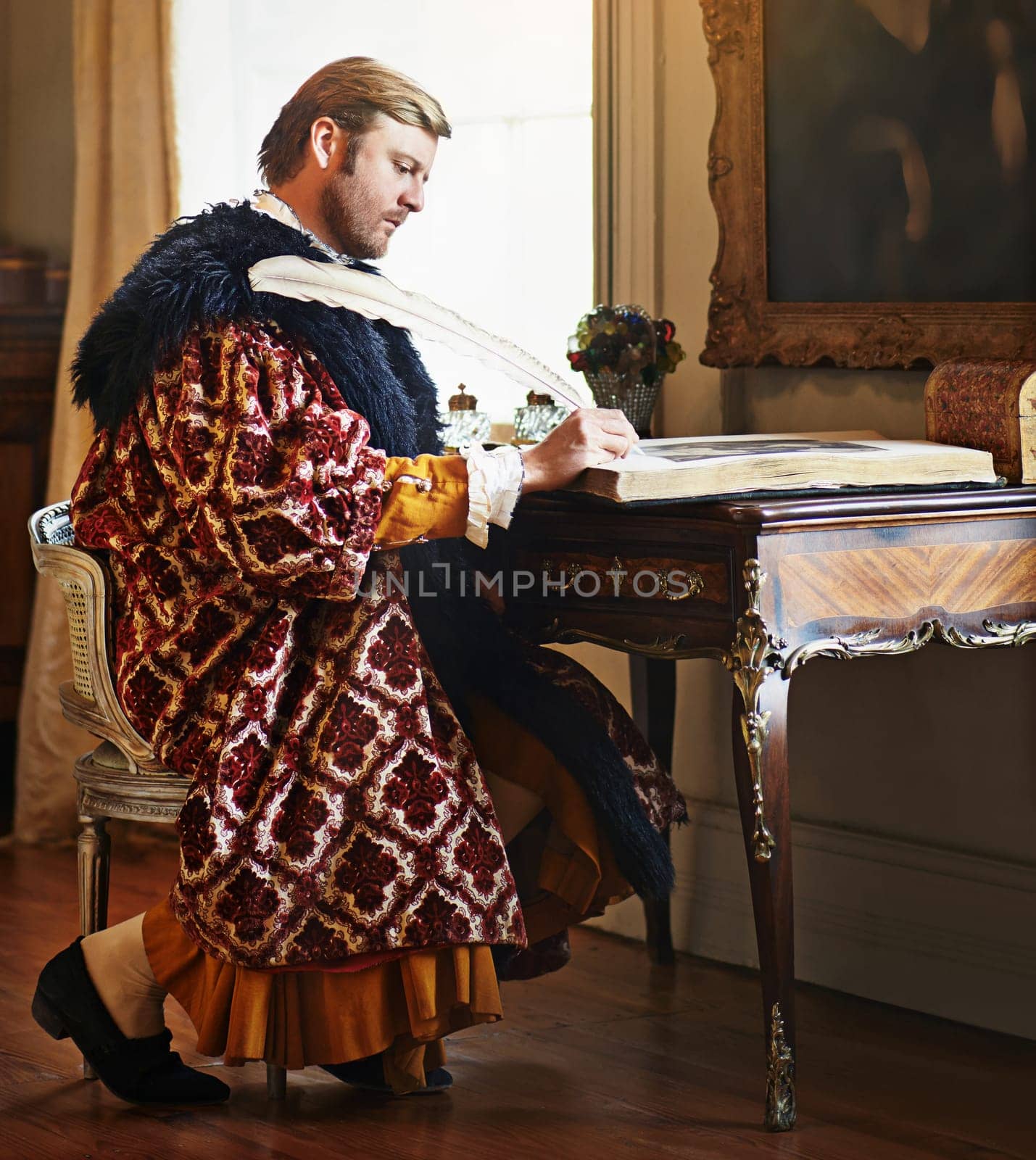 Man, aristocrat and writing with quill in book for renaissance, royalty aesthetic and letter in palace. Monarch, wealthy person and elegant clothes for cosplay, regal or communication in castle by YuriArcurs