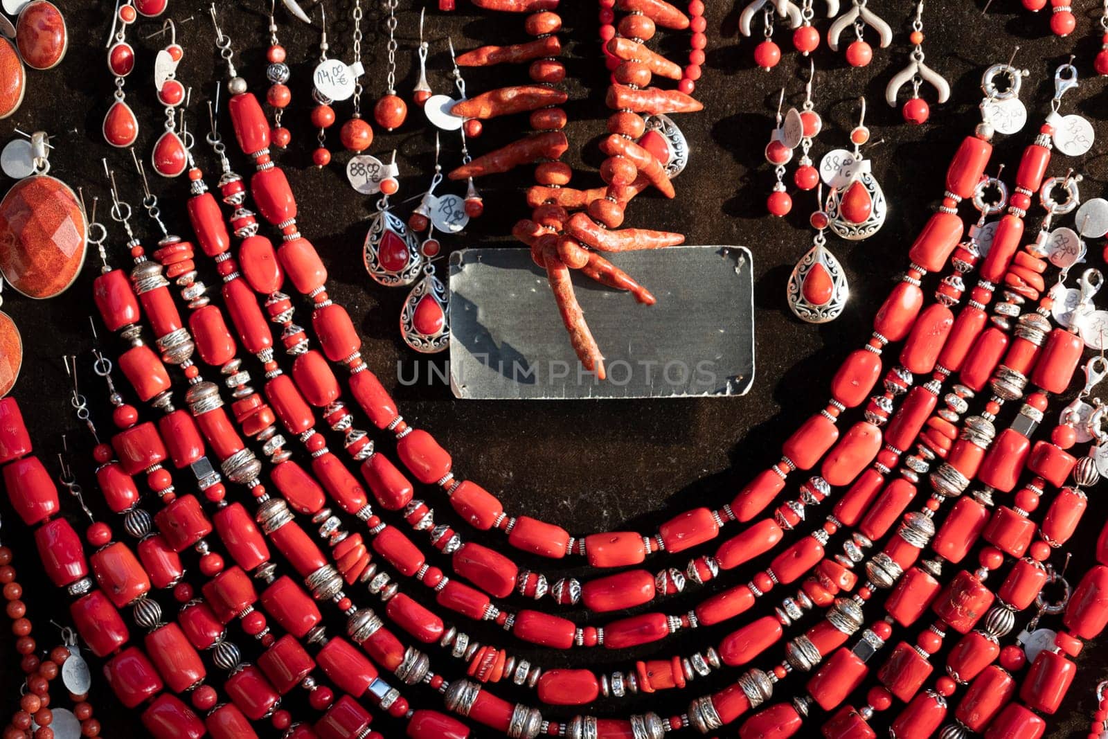 Coral necklage earrings jewelry on display stand in a shop market