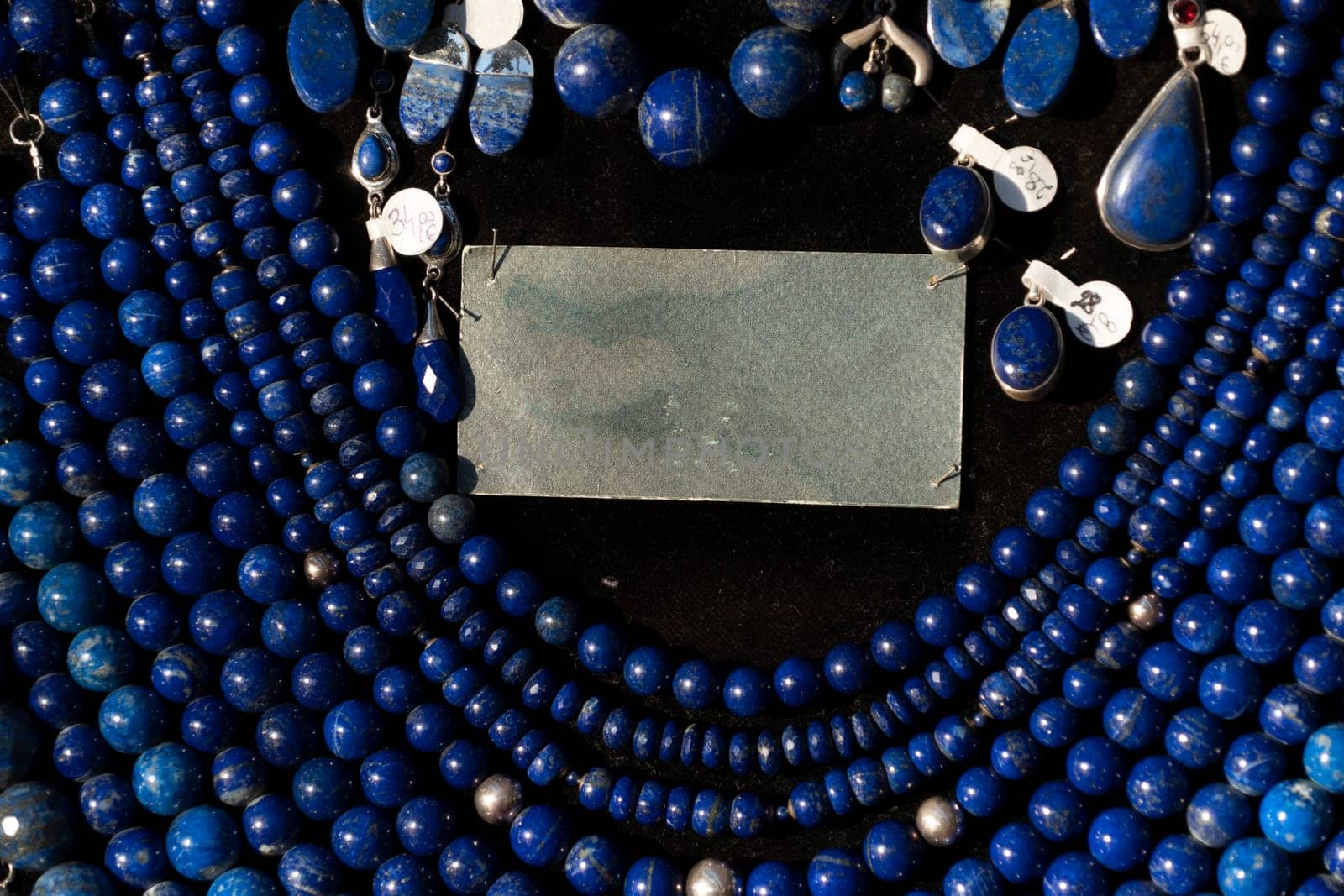 Lapislazuli necklage earrings jewelry on display stand in a shop market detail