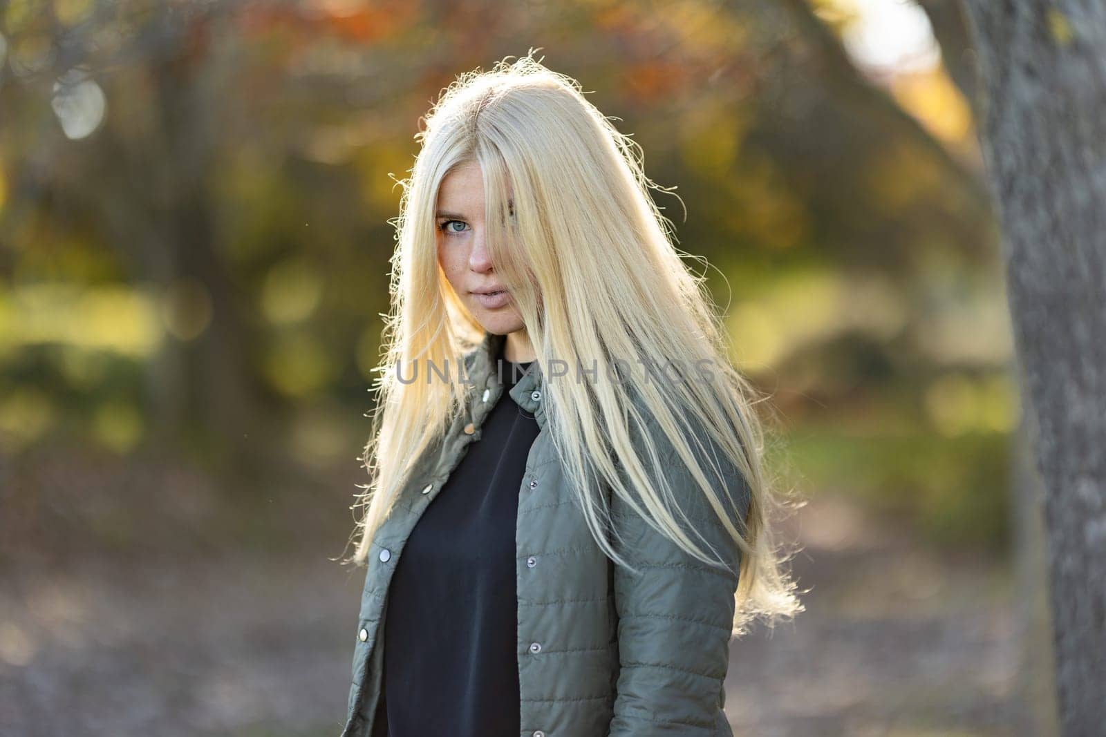 Young Woman with braces With Long Blonde Hair Standing by Tree by Studia72
