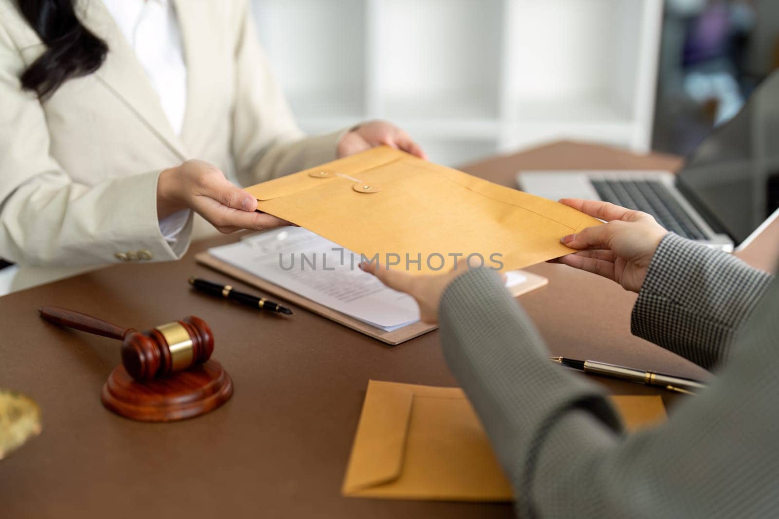 Businessman hands money envelope to lawyer in bribe over illegal business contract documents Investing, accepting bribes, corruption, fraud by nateemee
