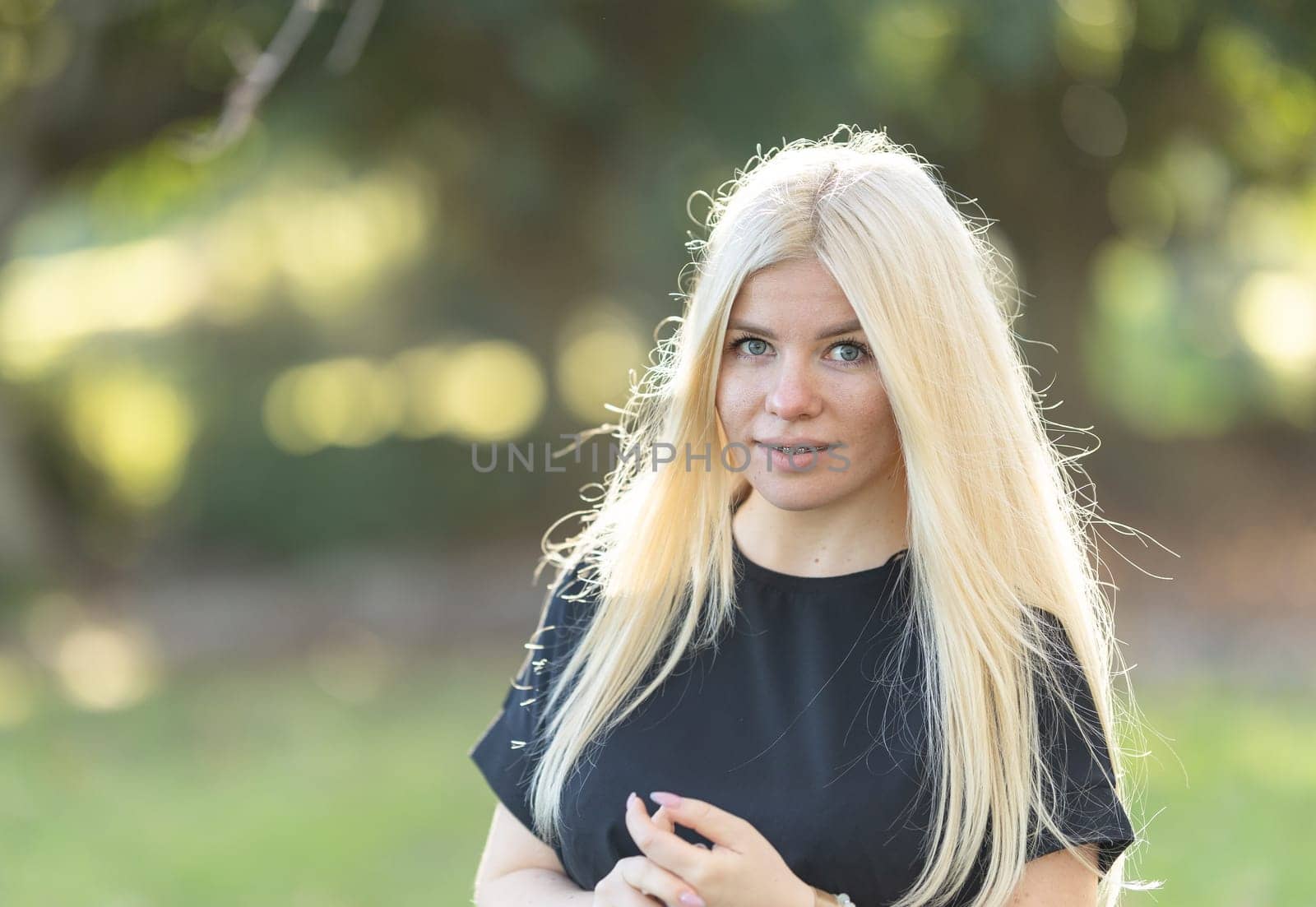 Smiling Woman with braces With Blonde Hair in Park by Studia72