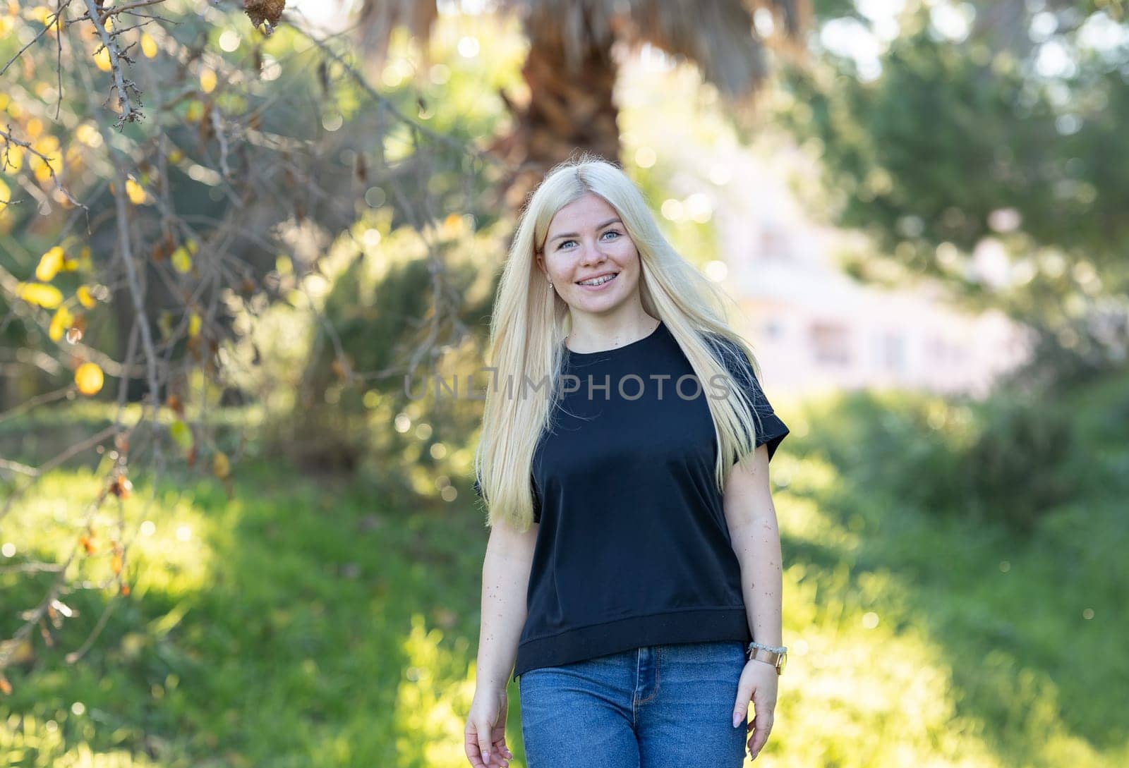 Smiling Woman with braces With Blonde Hair in Grass by Studia72