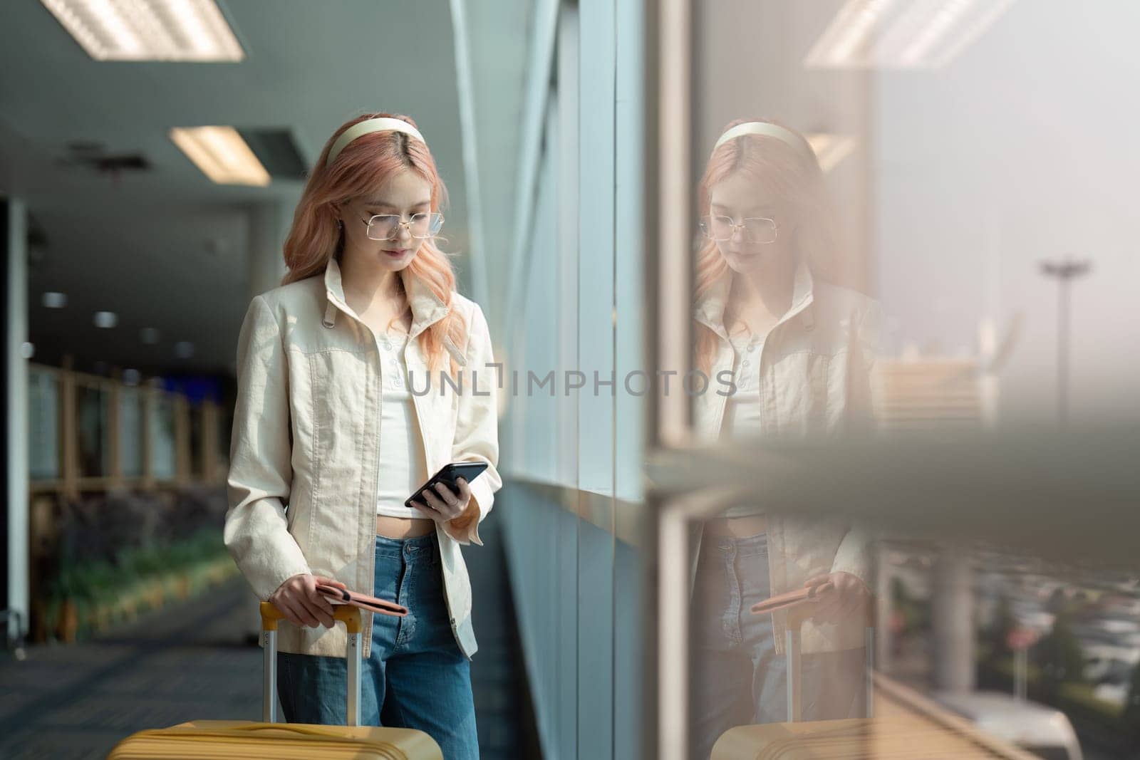 Traveler woman asian in airport and luggage for vacation, smile and talking on the phone check boarding ticket. Female traveler with suitcase, international and departure with passport and trip by nateemee