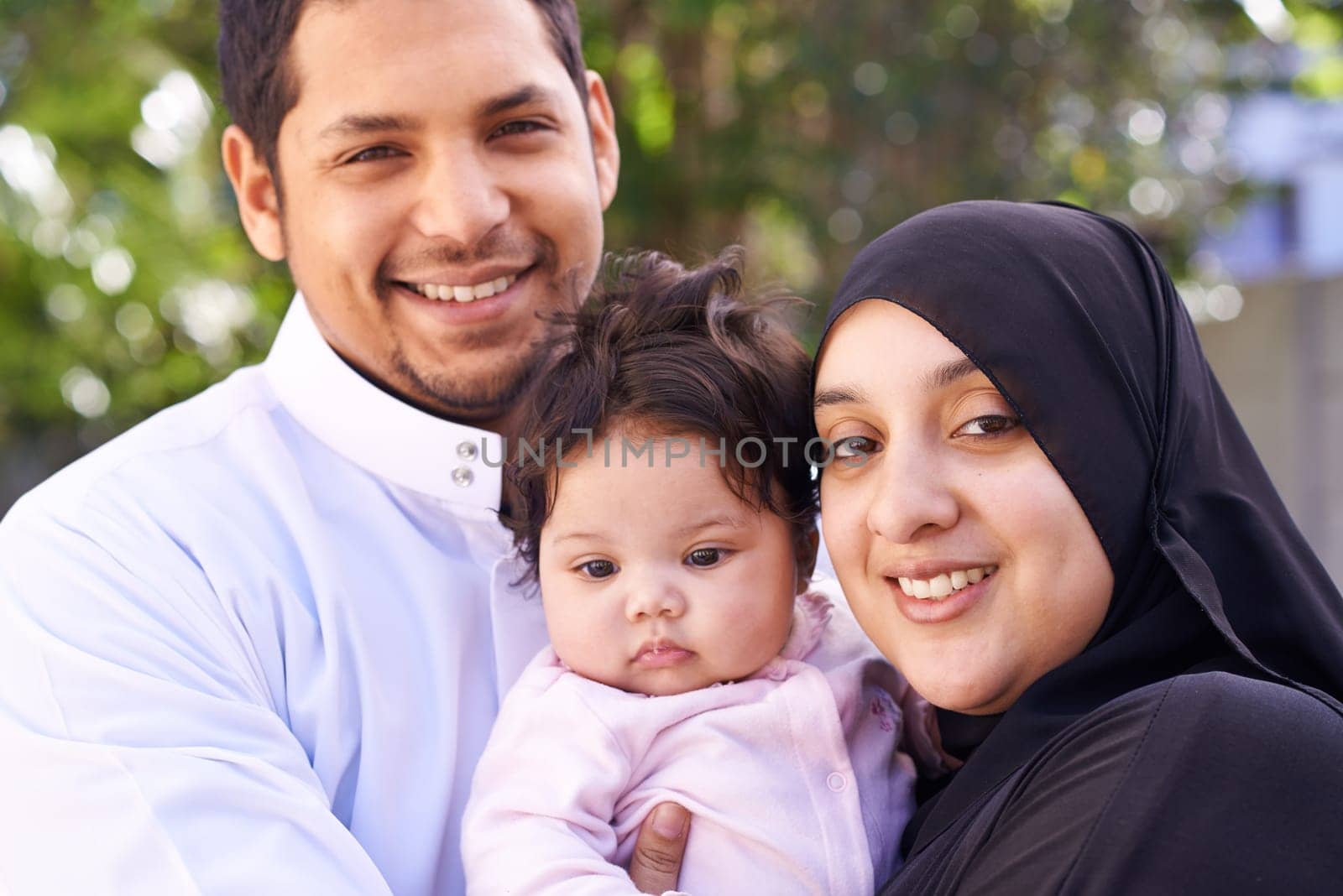 Muslim, family and portrait of parents with baby in park for bonding, Ramadan and outdoors together. Islam, happy and mother, father and newborn infant for love, childcare or support in garden by YuriArcurs