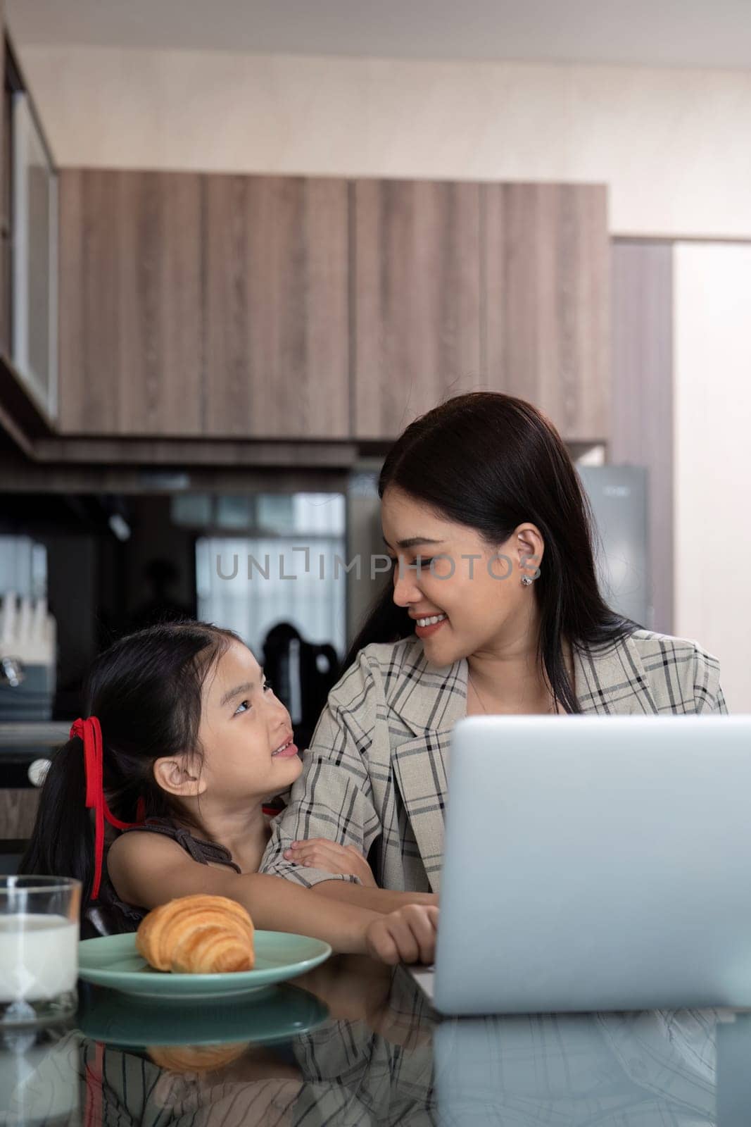 Working mom work from home office. businesswoman and cute child using laptop work freelancer workplace in home, Lifestyle family moment.