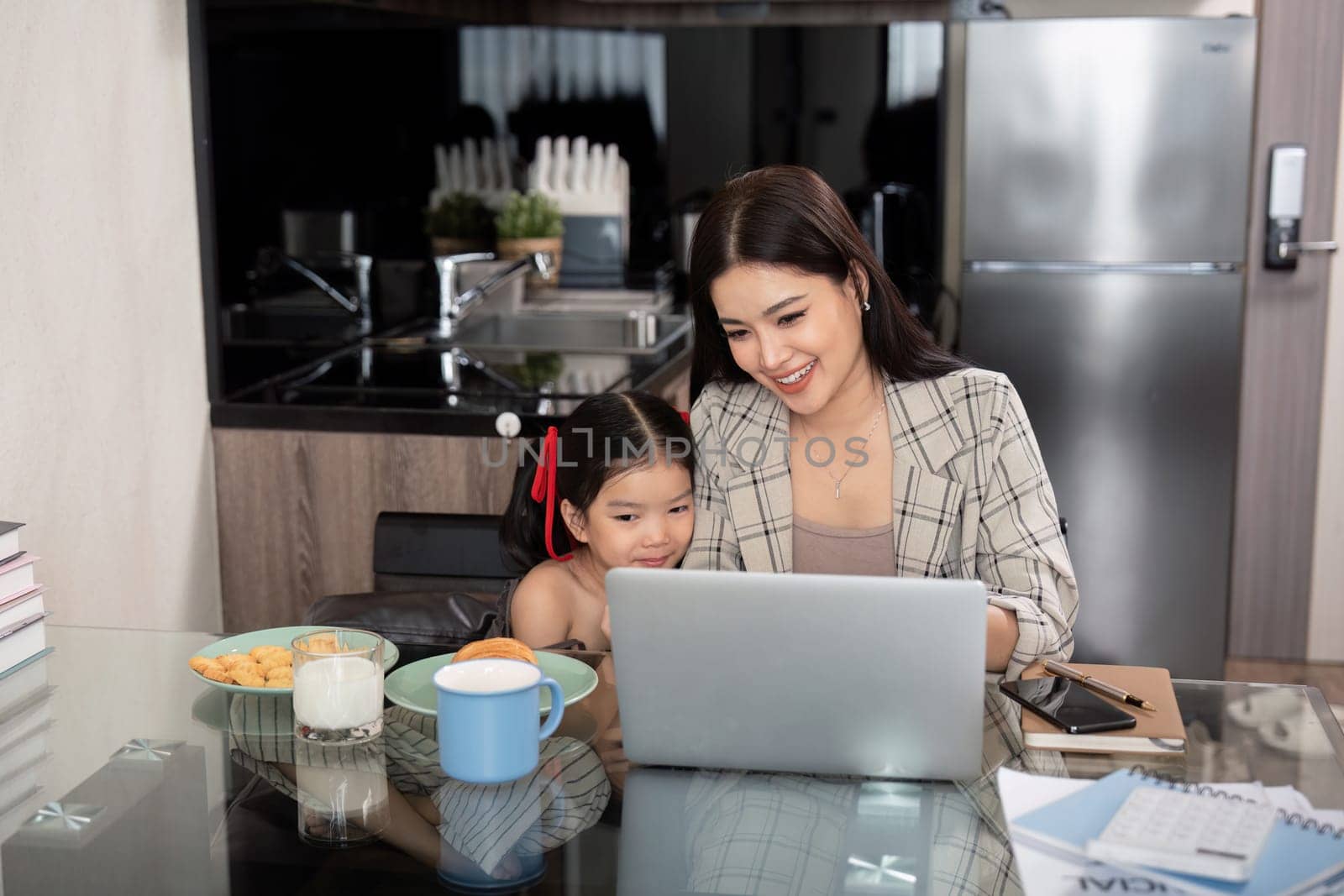 Working mom work from home office. businesswoman and cute child using laptop work freelancer workplace in home, Lifestyle family moment by nateemee