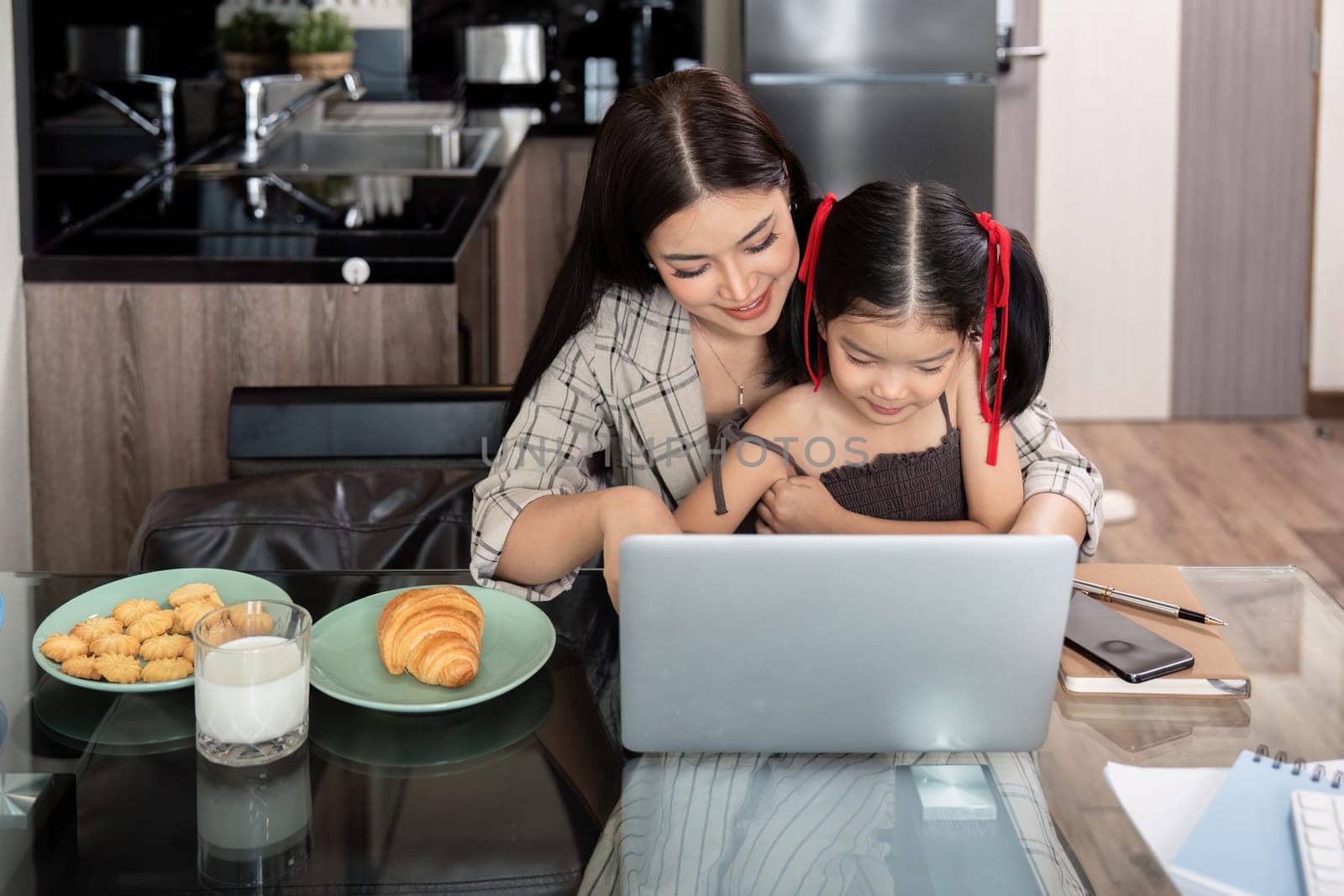 Working mom work from home office. businesswoman and cute child using laptop work freelancer workplace in home, Lifestyle family moment by nateemee