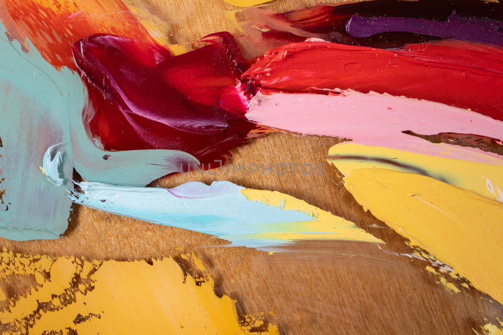 Fragment of multicolored texture painting on plywood. Abstract art background. oil on canvas. Rough brushstrokes of paint. Closeup of a painting by oil and palette knife. Highly-textured, high quality details.
