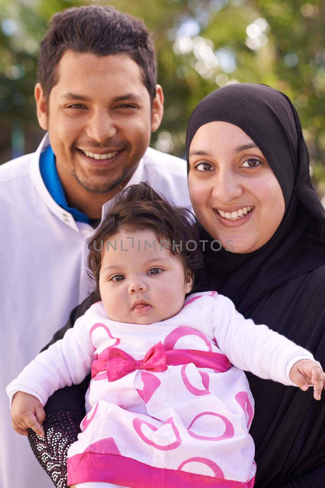 Portrait of mother, father and baby in park for bonding, relationship and outdoors together. Muslim family, nature and happy parents with newborn infant for love, childcare and support in garden by YuriArcurs