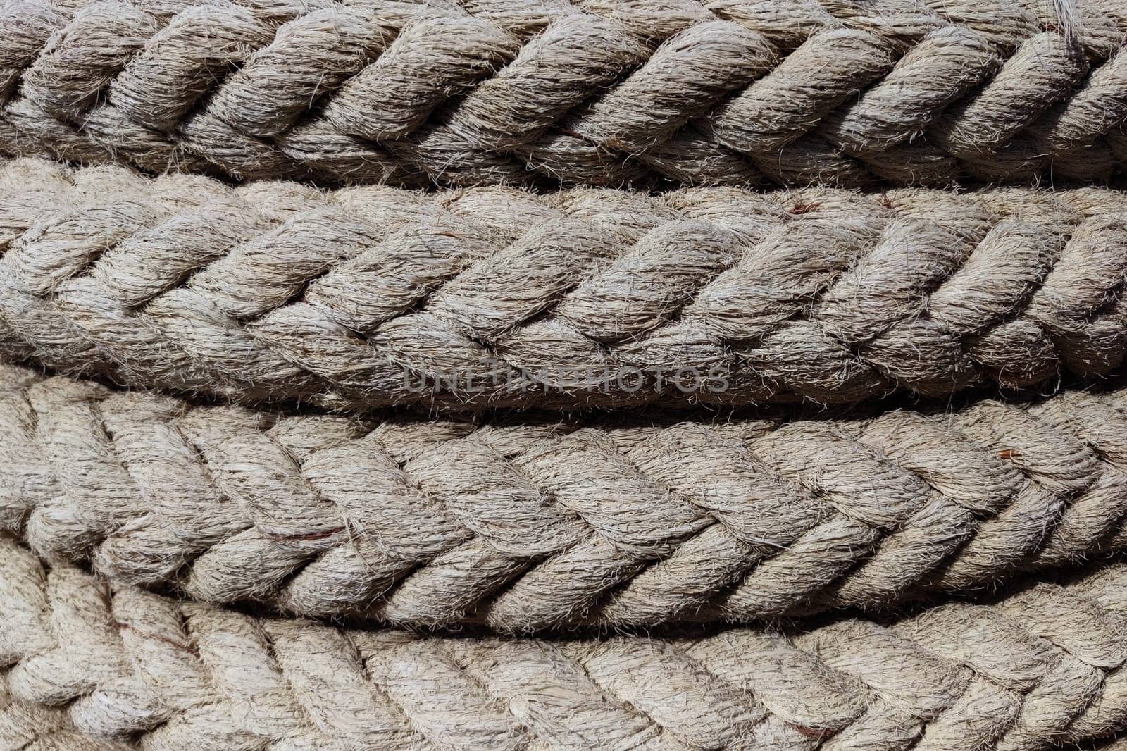 twisted braided rope closeup for natural textile background by Annado