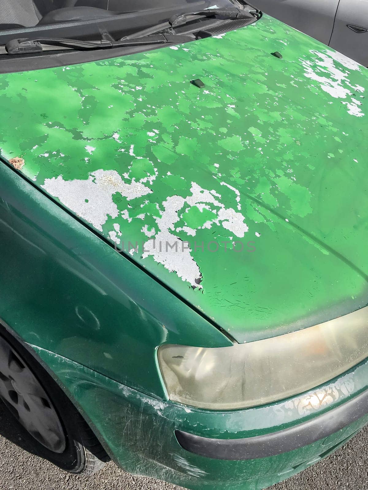 Cracked and peeling paint on an old car for background.