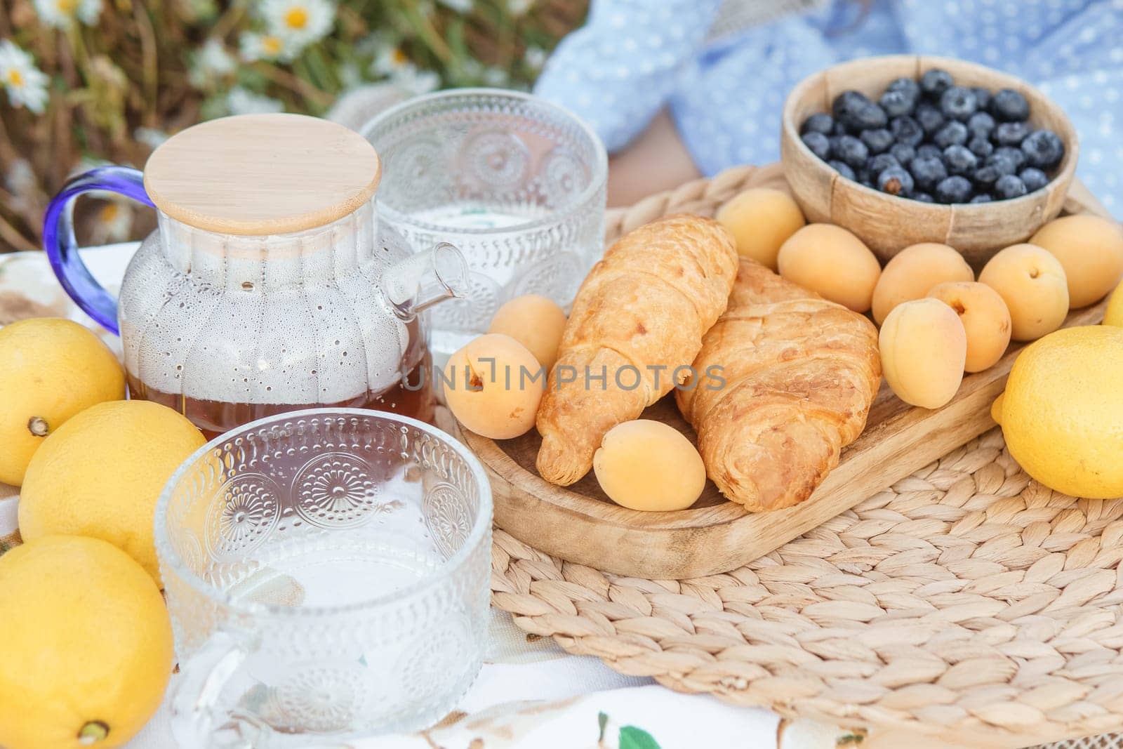 Picnic in the chamomile field. A large field of flowering daisies. The concept of outdoor recreation