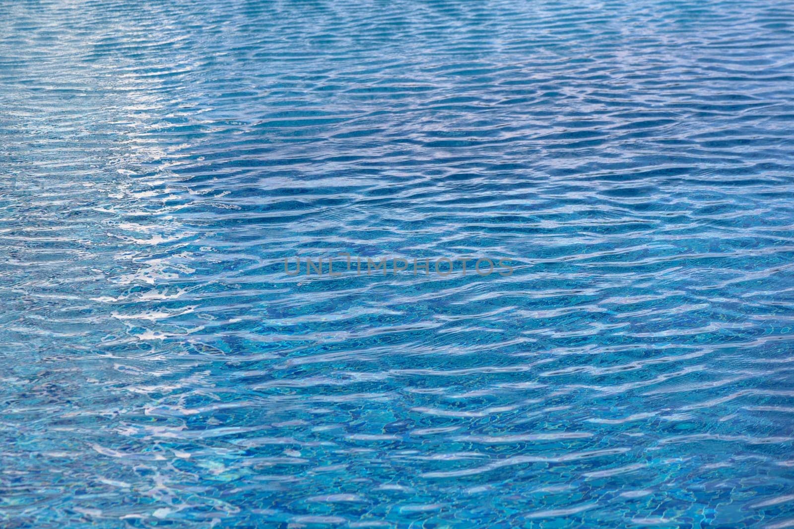 Beautiful sun reflections of water in the pool. Blue water. Background. Pure water.2