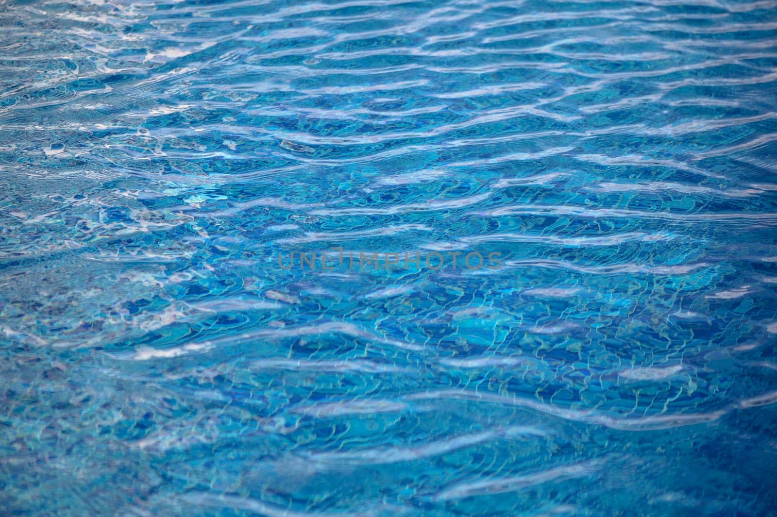 Beautiful sun reflections of water in the pool. Blue water. Background. Pure water.3