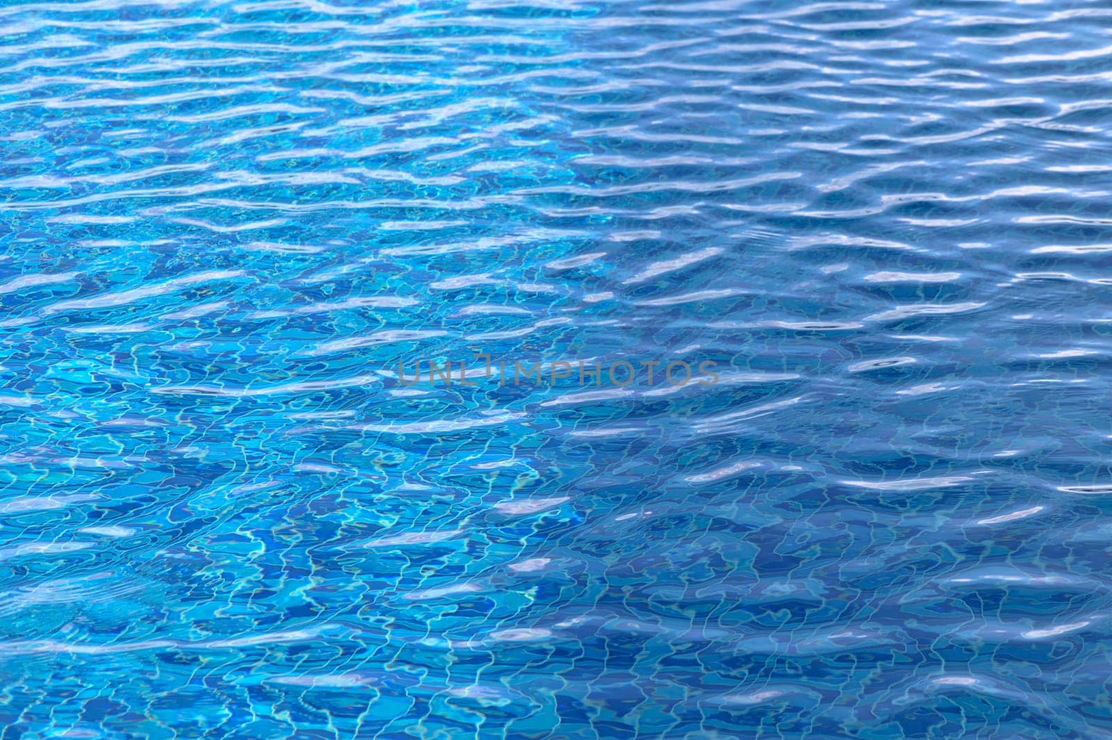 Beautiful sun reflections of water in the pool. Blue water. Background. Pure water.4