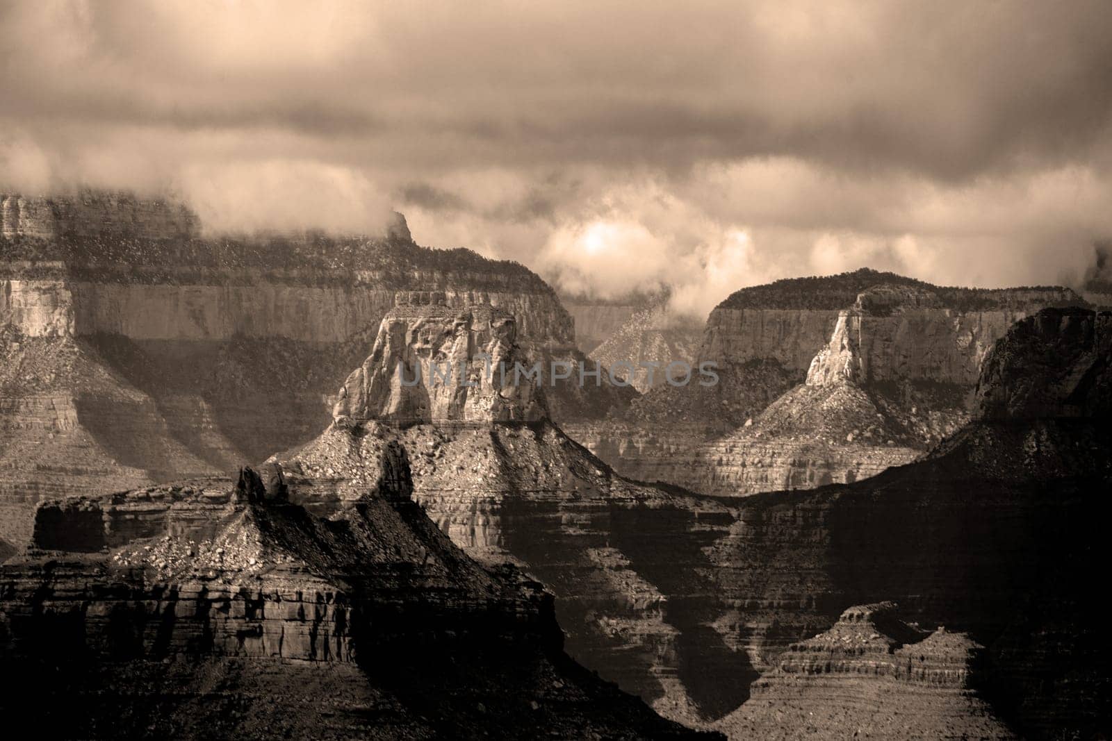 Passing rain storm produces clouds that filter the sunlight at Grand Canyon National Park, Arizona