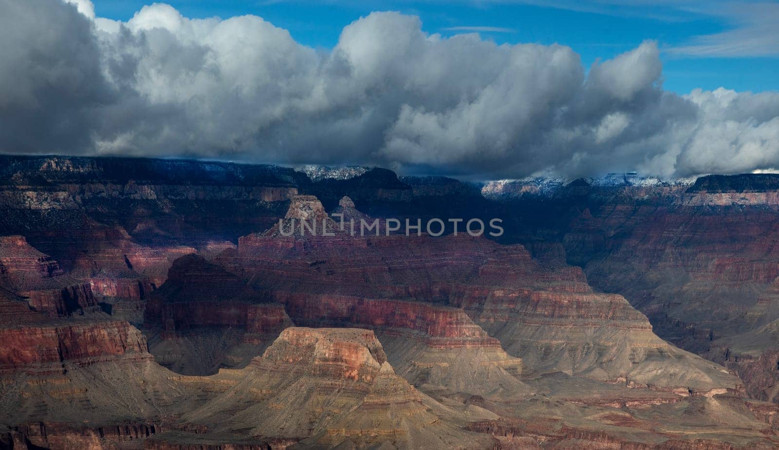 Passing rain storm produces clouds that filter the sunlight at Grand Canyon National Park, Arizona