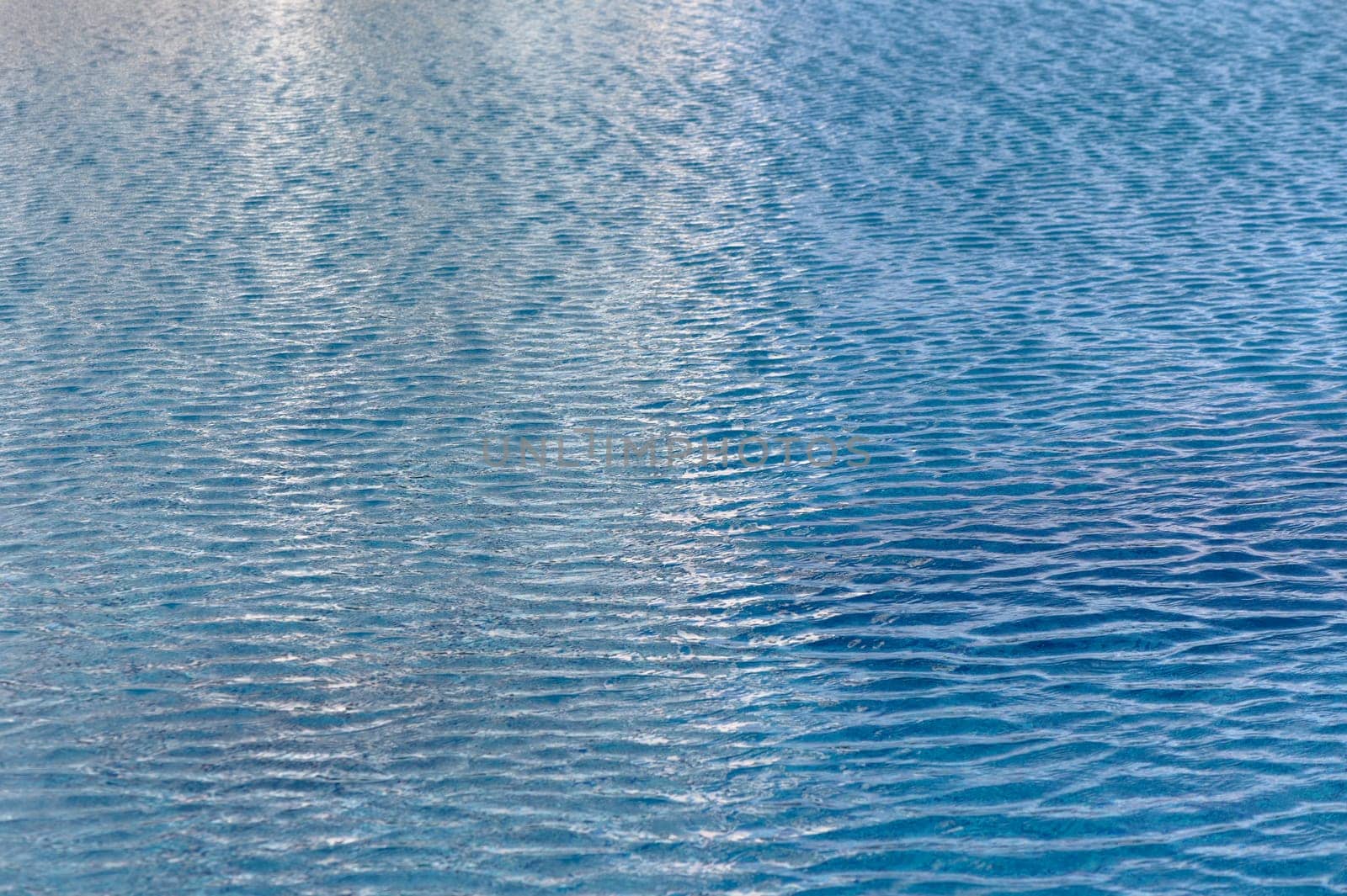 Beautiful sun reflections of water in the pool. Blue water. Background. Pure water.