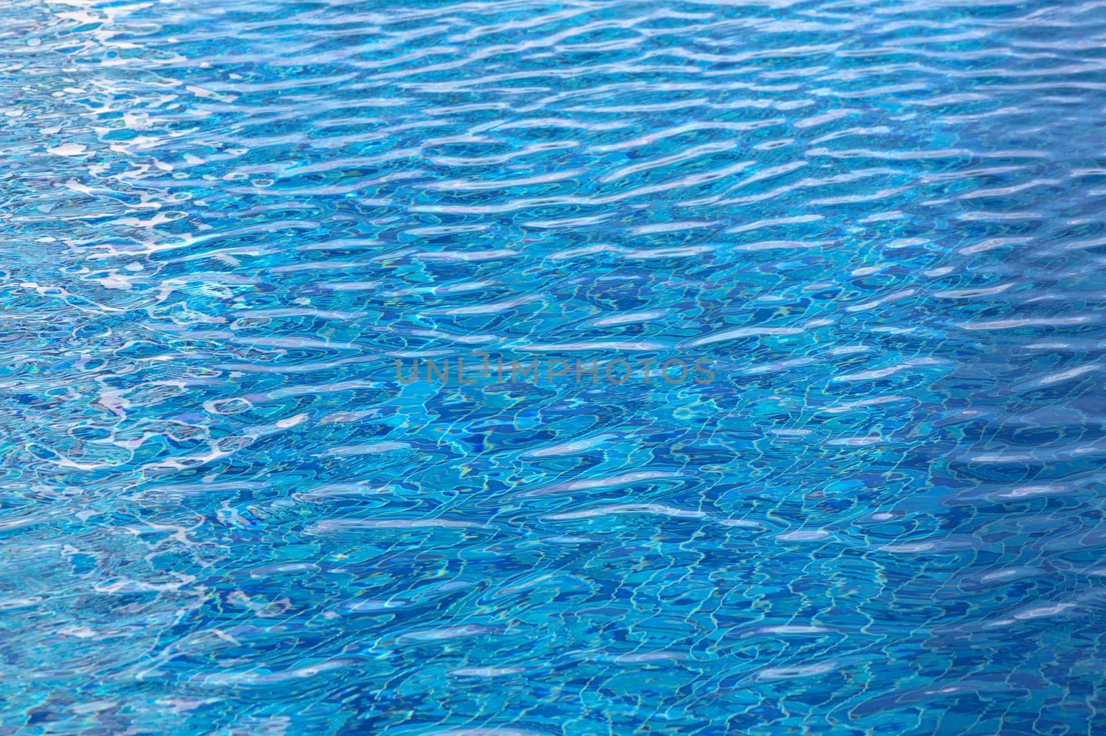 Beautiful sun reflections of water in the pool. Blue water. Background. Pure water.1