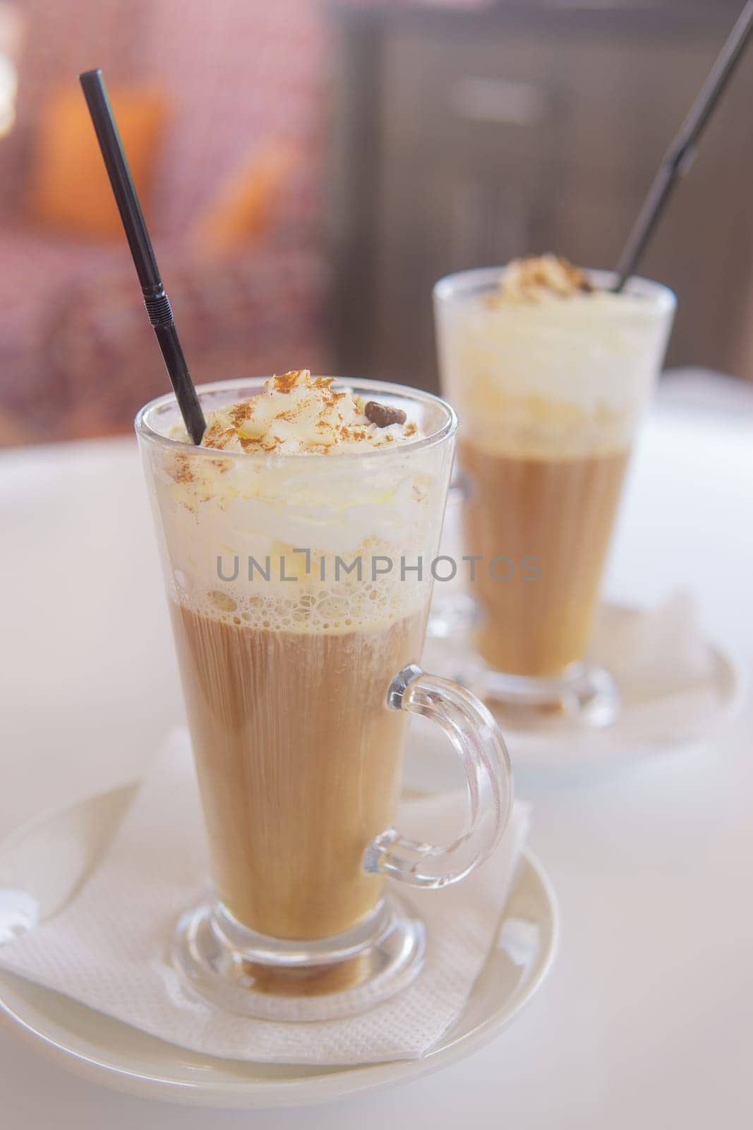 coffee is served in a tall glass glass with a straw. The concept of coffee drinks from the bar menu.