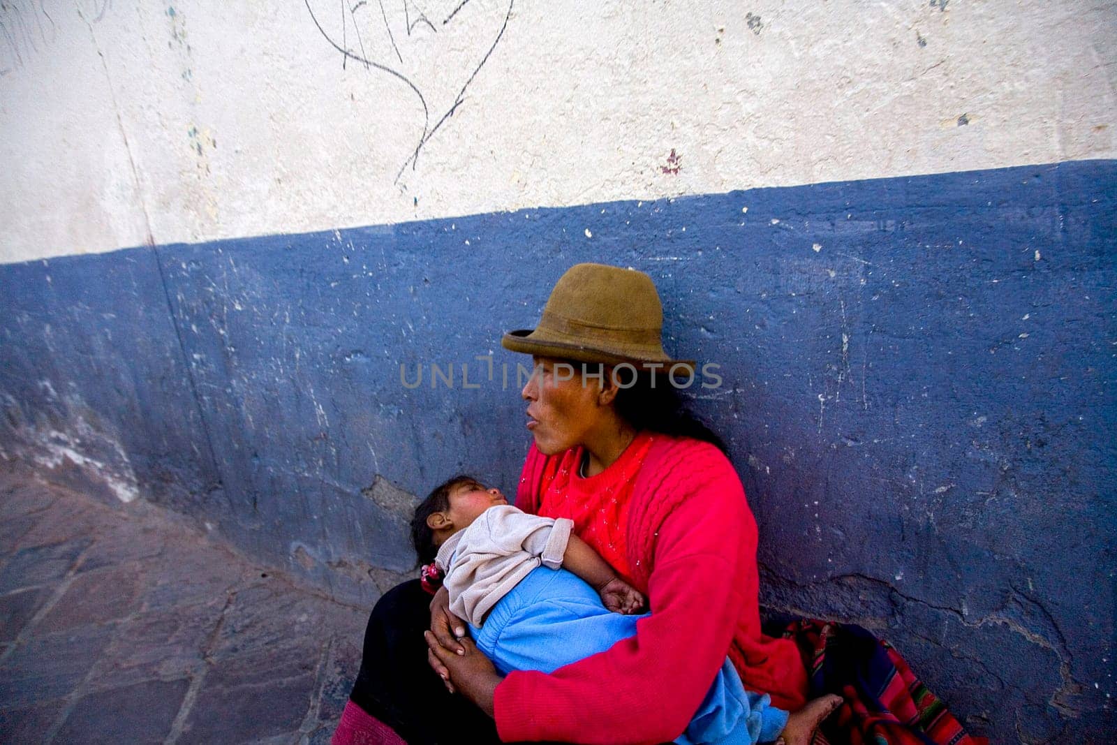 MOTHER HANDLES NEWBORN IN ALLEY IN CUZCO, PERU