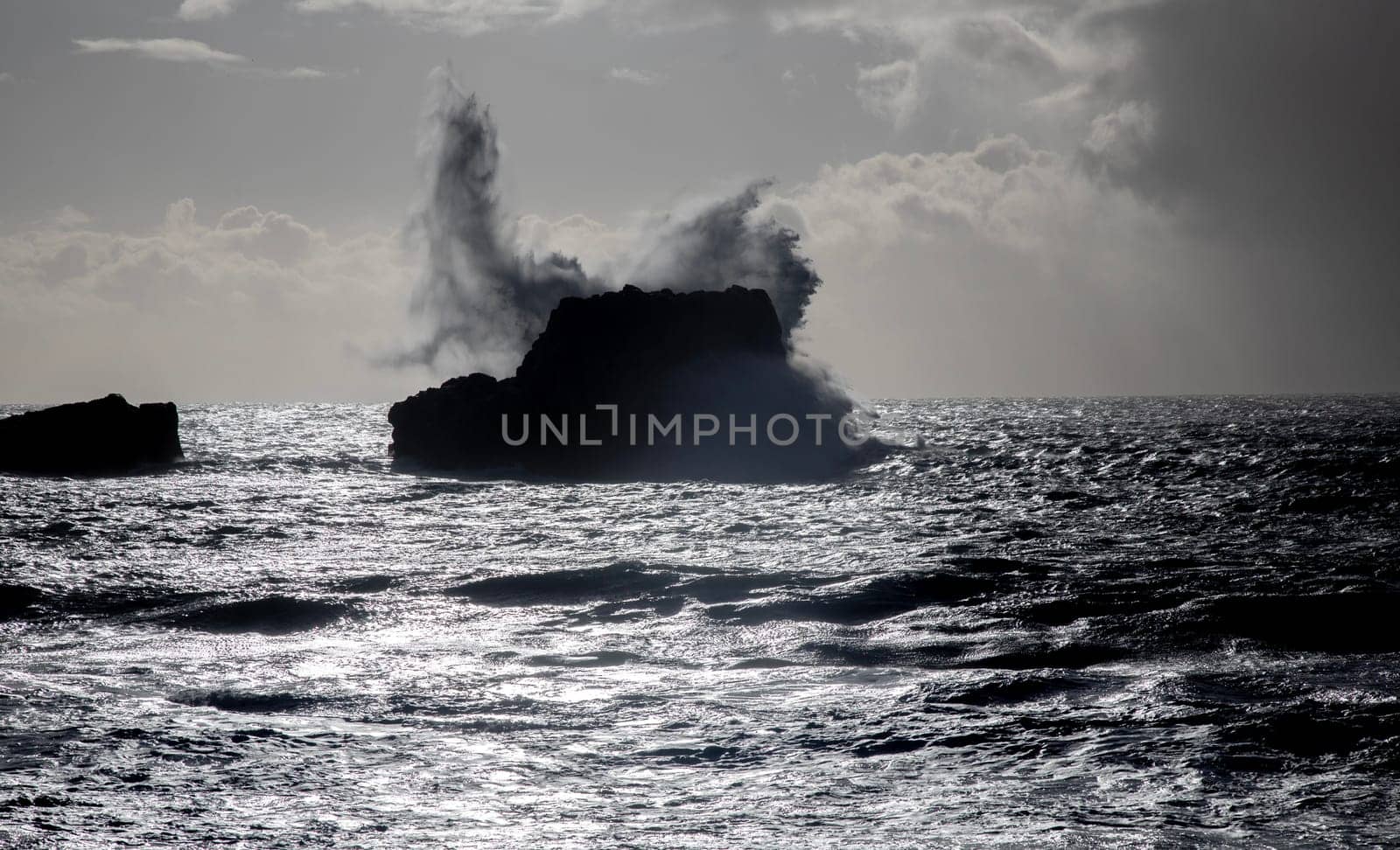 Powerful waves crash upon the beach along the Pacific Ocean at San Simeon, California