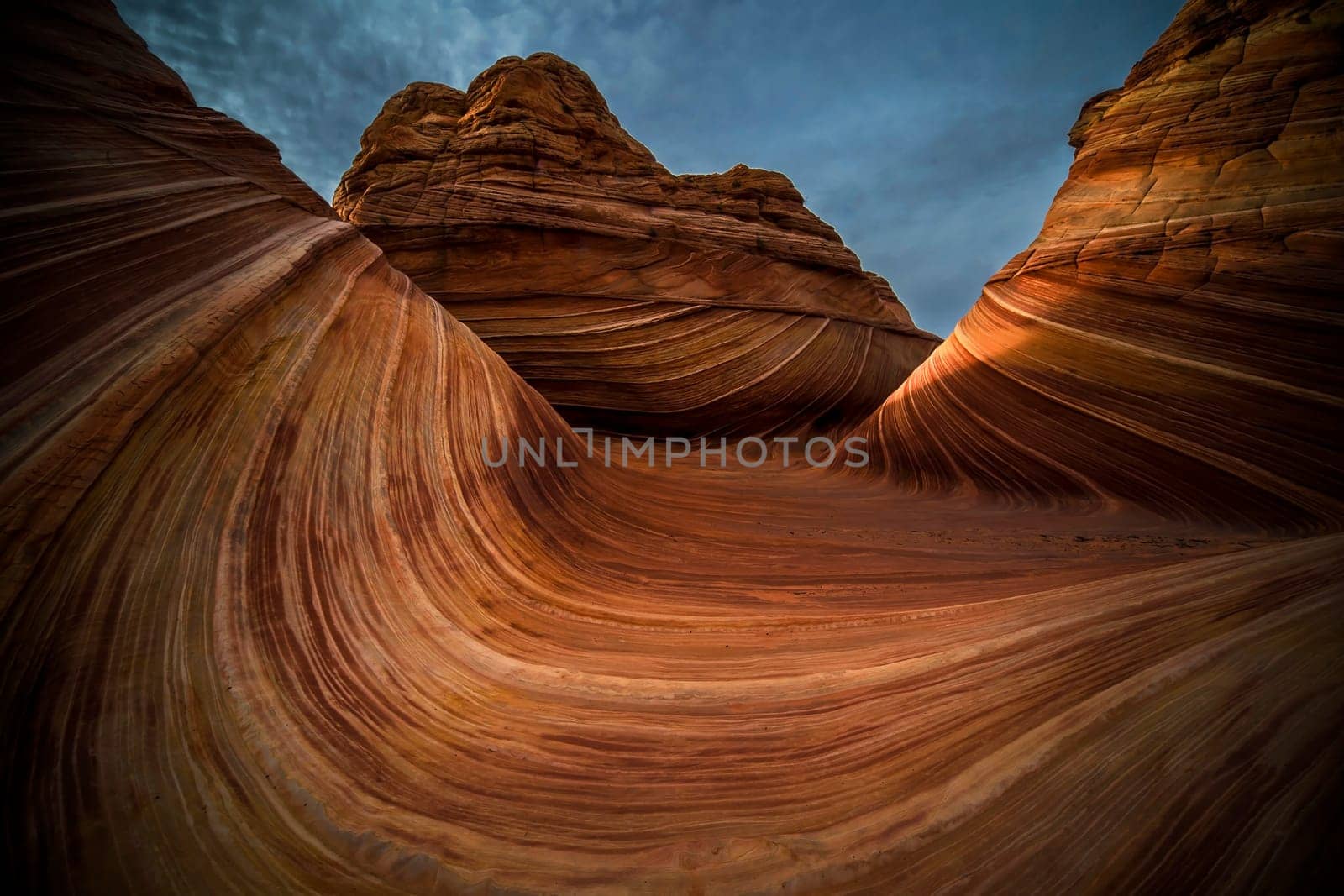 Unusual sandstone rock formations resembling waves make up the landscape at The Wave at North Coyote Buttes on the Utah/Arizona border