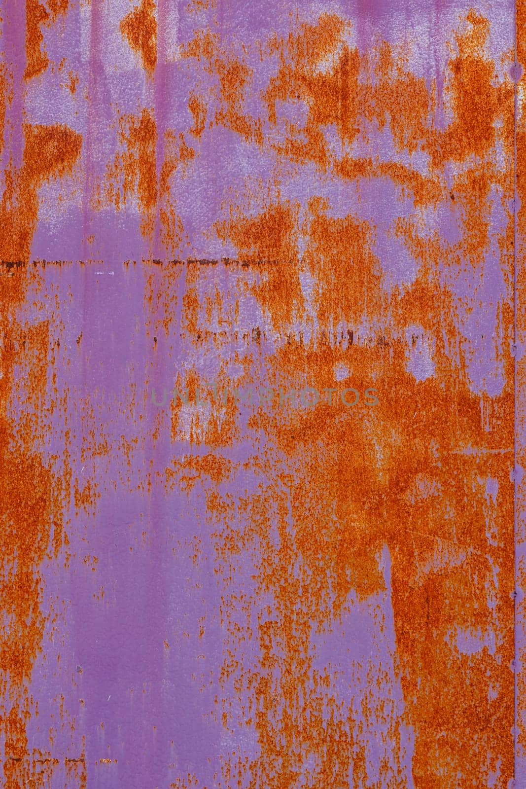 rusty flat sheet metal surface full-frame background and texture with leftovers of pink paint by z1b