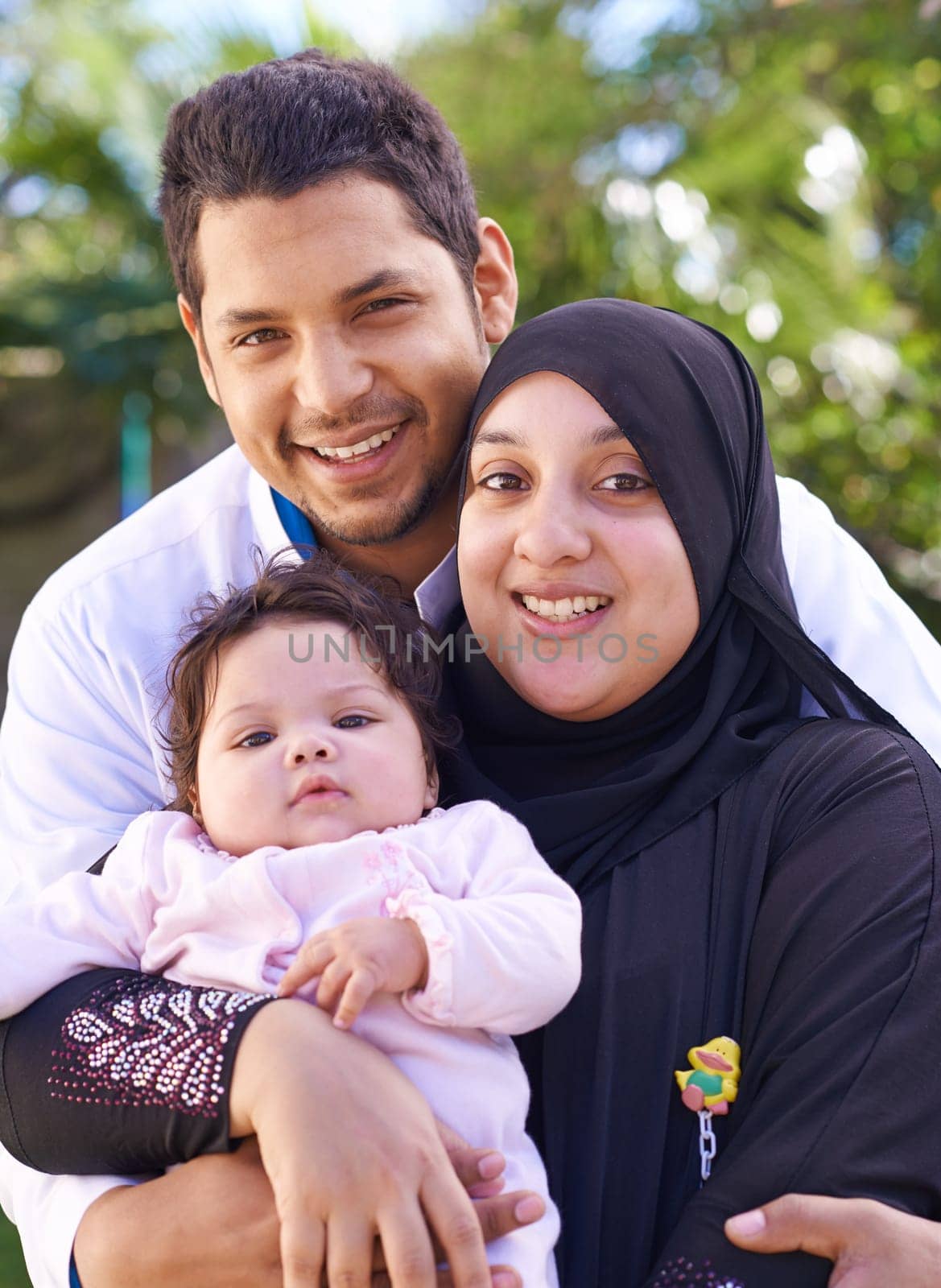 Muslim, park and portrait of parents with child for bonding, ramadan and outdoors together. Islam, happy family and mother, father and newborn infant for love, childcare and support in nature by YuriArcurs