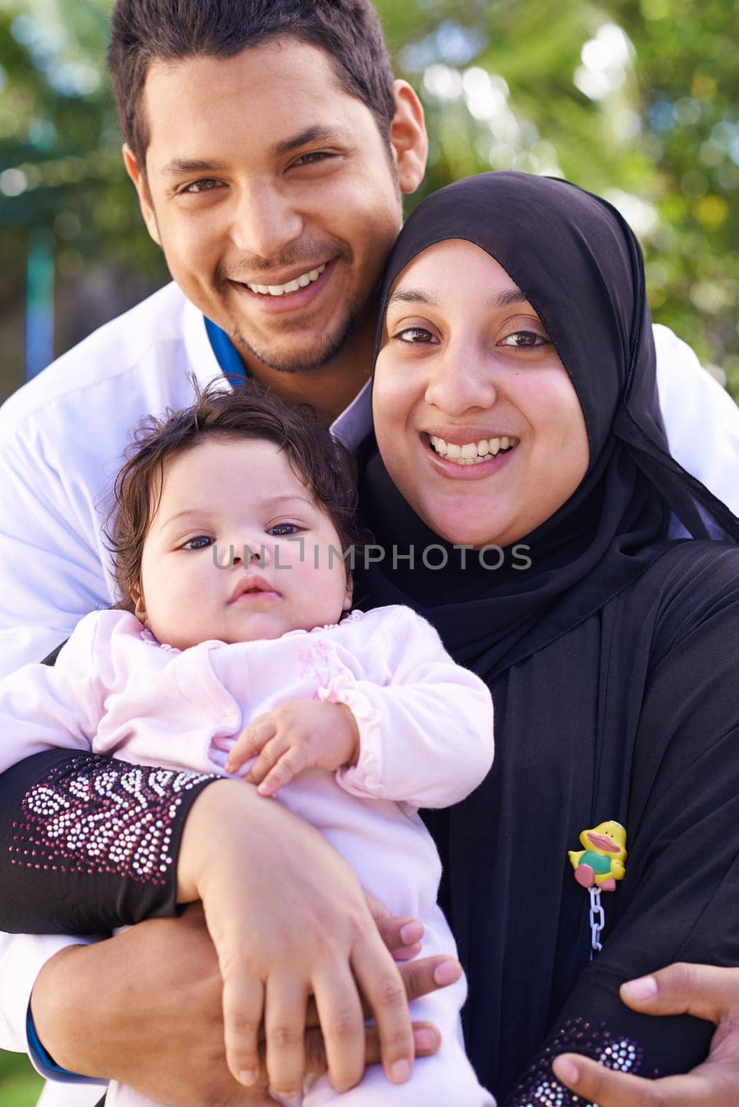 Muslim, park and portrait of parents with baby for bonding, ramadan and outdoors together. Islam, happy family and mother, father and newborn infant for love, childcare and support in garden.