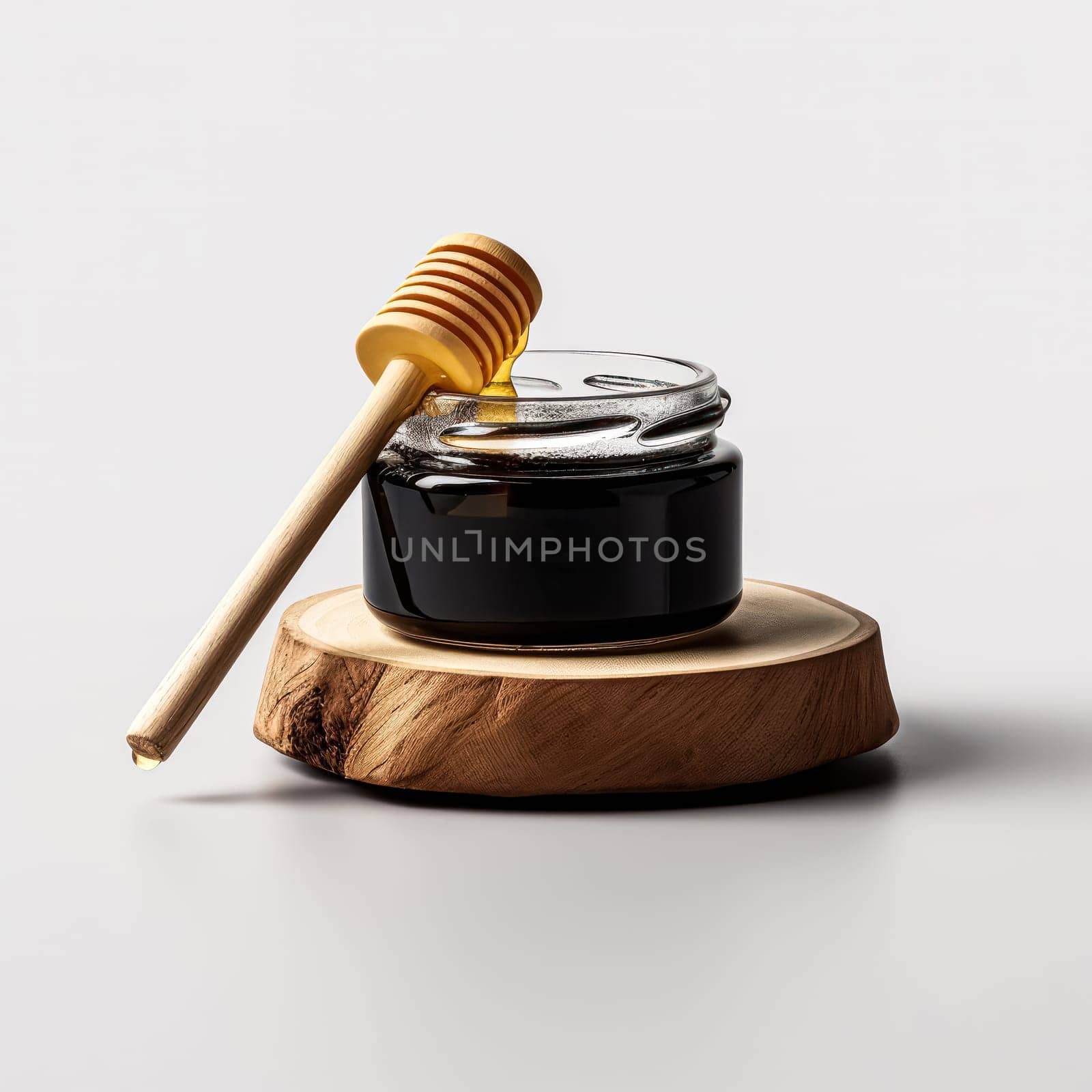 A wooden spoon is next to a jar of honey. The spoon is made of wood and has a curved handle. The jar of honey is in a glass container and is sitting on a white background