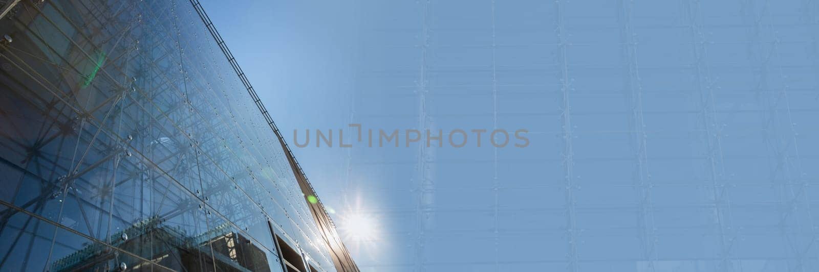 Glass facade with steel handles as a frame. Modern construction in Lublin. Transparent walls of the building.