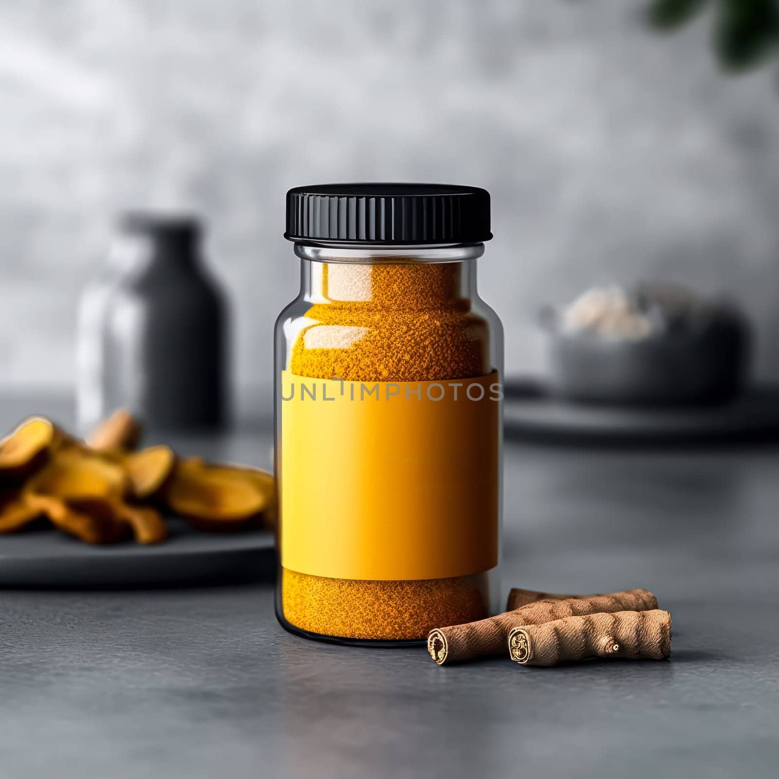 A jar of yellow mustard sits on a table next to a jar of spices. The mustard jar is black and has a label on it. The scene is simple