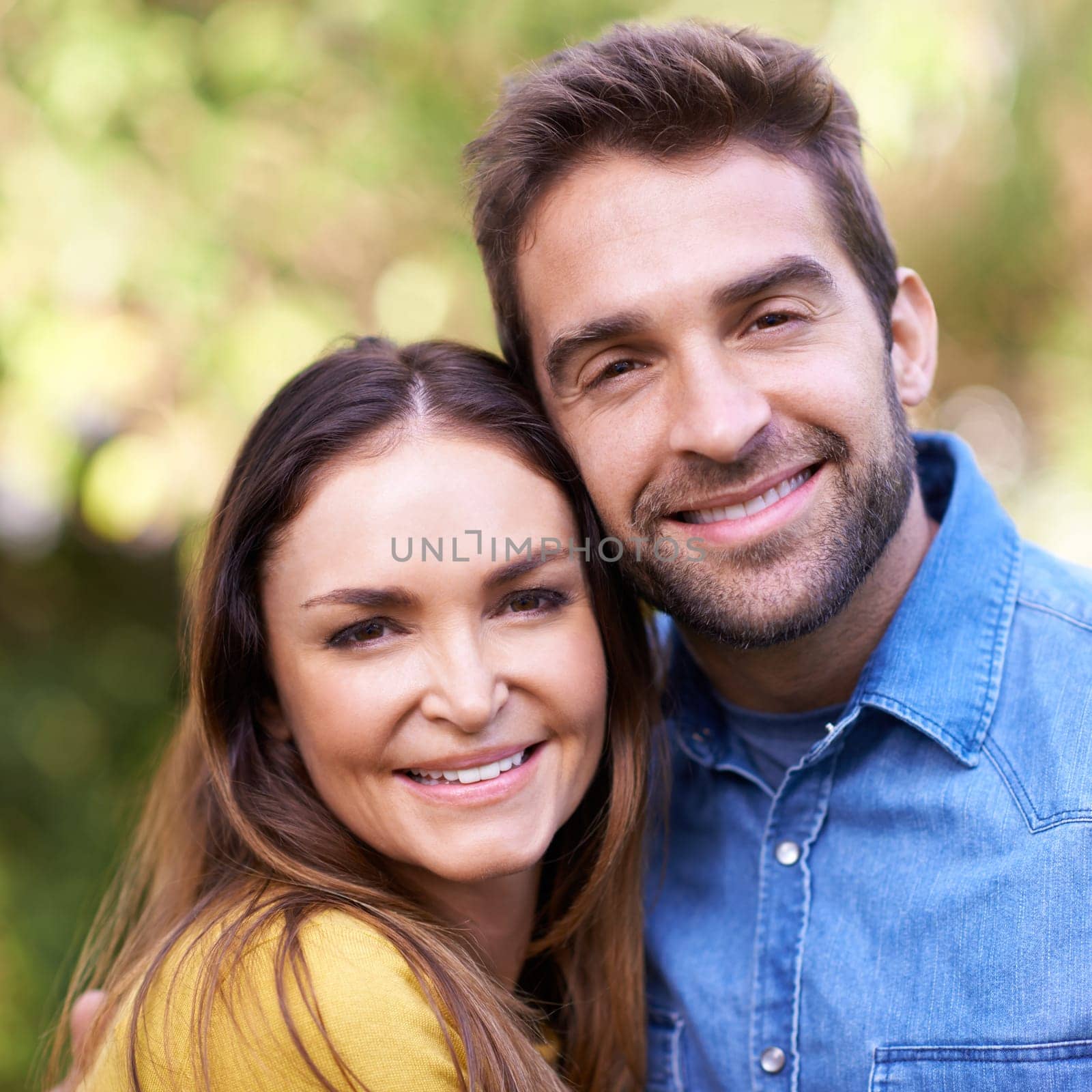 Face, couple and outdoor with smile in hug for bonding, love and support to relax together. Portrait, relationship and happy with fun at park as family, soulmate and commitment on break or holiday by YuriArcurs