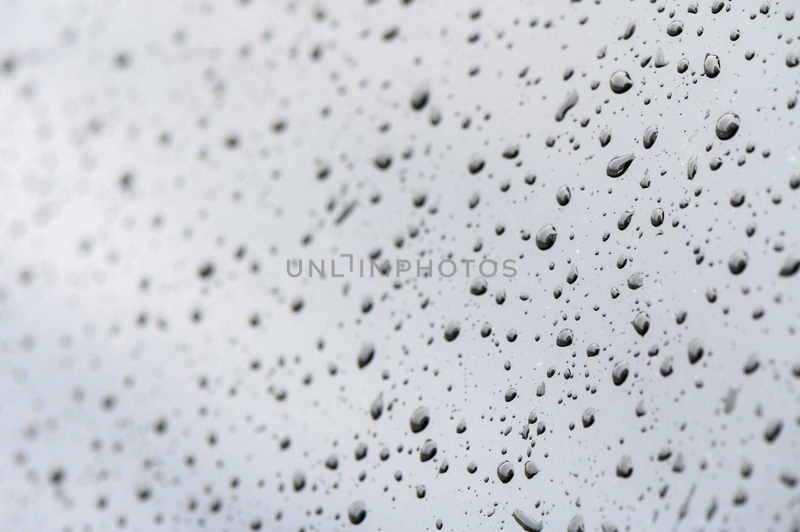 Rainy day, water droplets on car window's side mirror.1