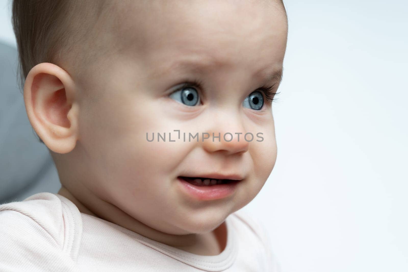 Portrait of crying 1-year old baby upset of being hungry and tired by Mariakray