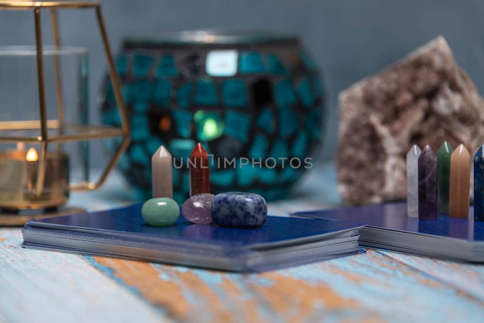 A tarot card reading setup with an array of colorful healing crystals on a weathered wooden table, invoking a sense of mysticism. by jbruiz78