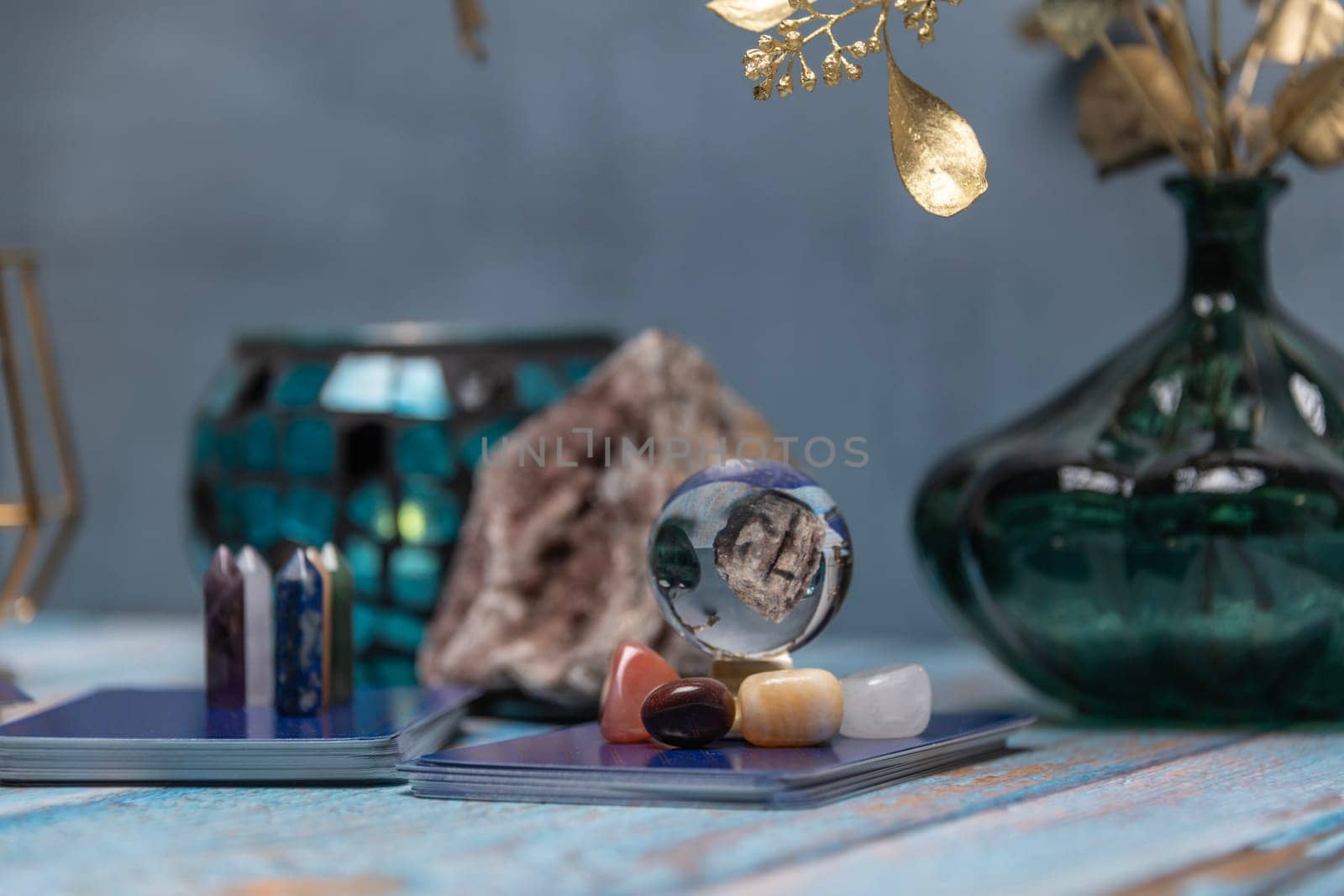 A tarot card reading setup with an array of colorful healing crystals on a weathered wooden table, invoking a sense of mysticism. by jbruiz78